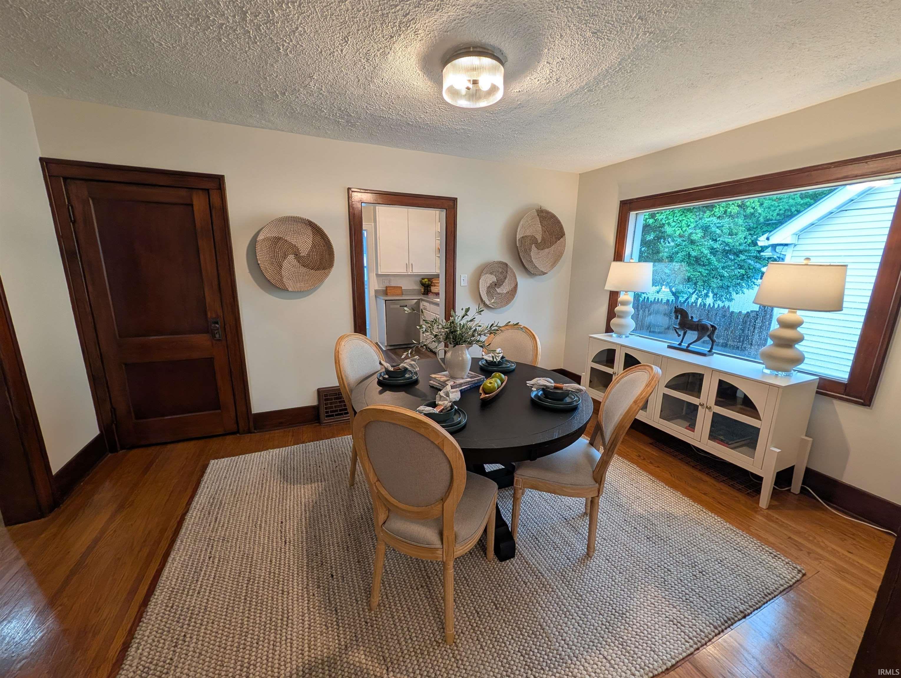 Dining area featuring hardwood flooring and a large window