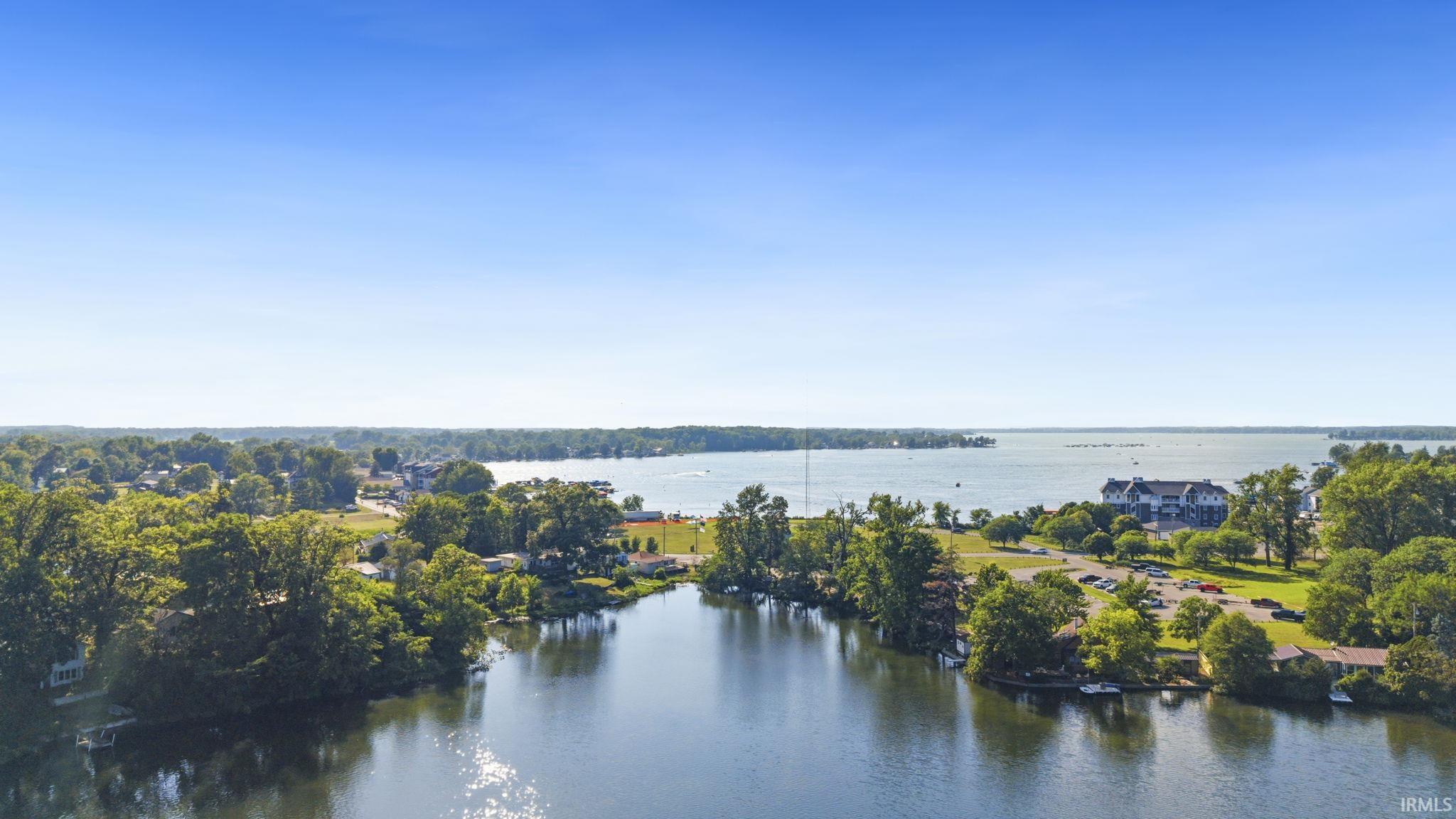 Expansive waterfront setting featuring a tranquil canal leading to a large body of water