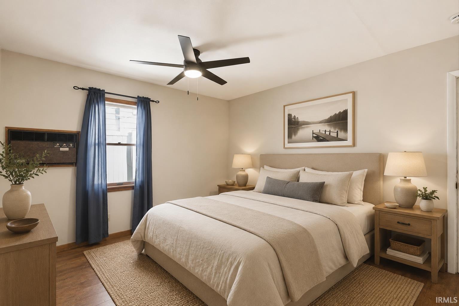 Bright room featuring wood-finish flooring and a central ceiling fan