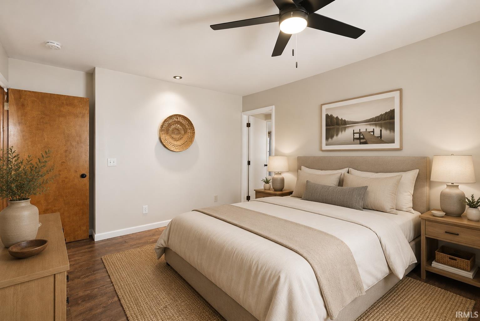 Bedroom featuring wood-finish flooring, recessed lighting, a ceiling fan with integrated light, and a solid wood door