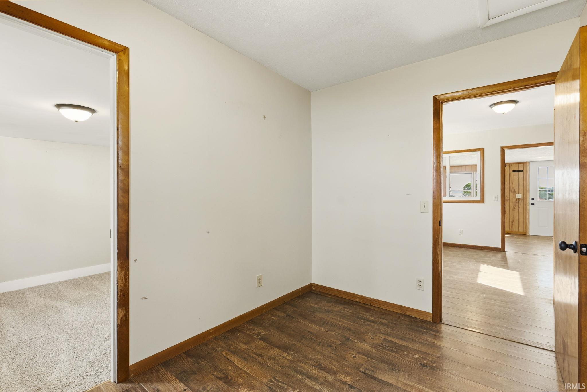 Interior space featuring wood-finish flooring and white painted walls