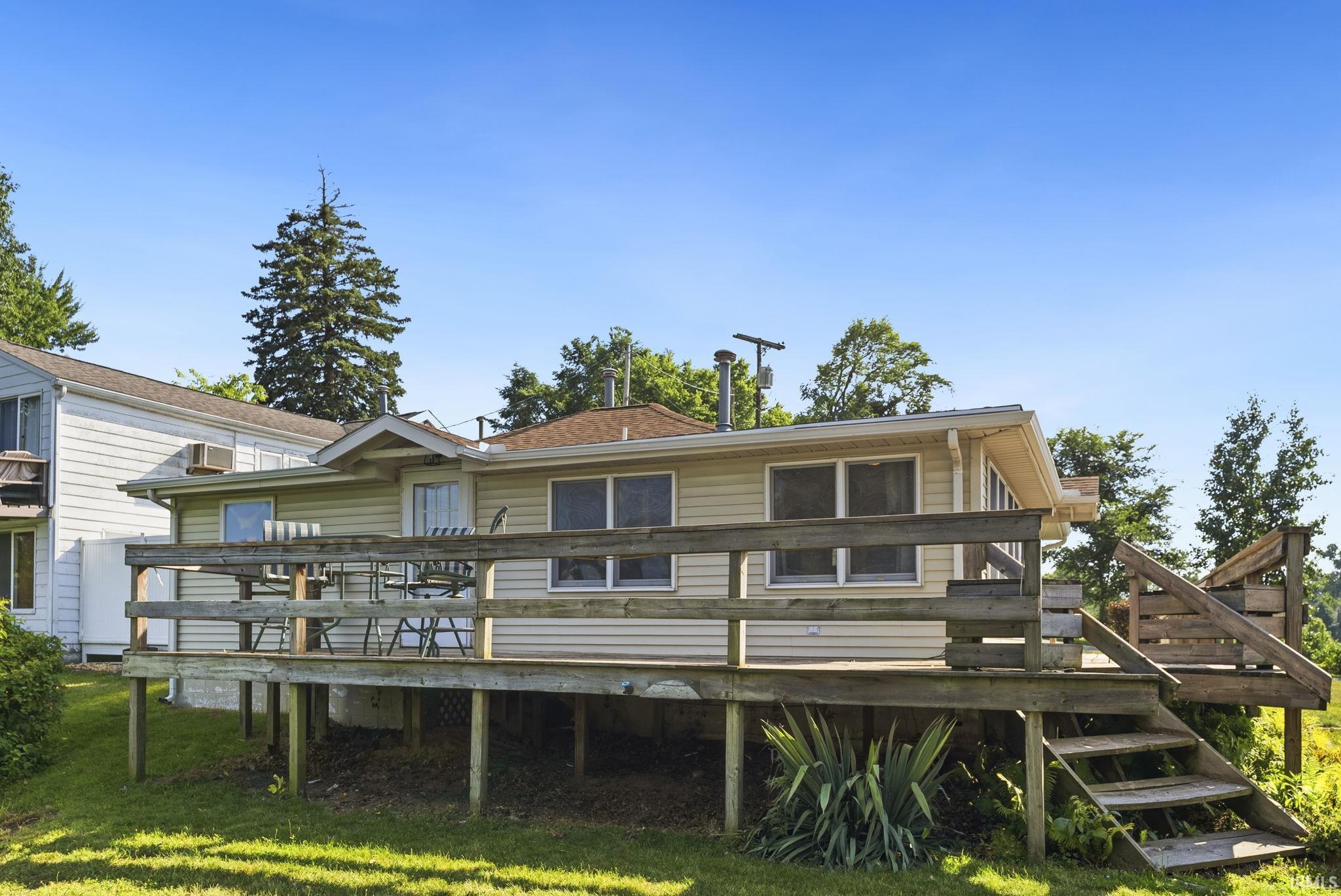 Expansive wooden deck with railing, offering outdoor living space