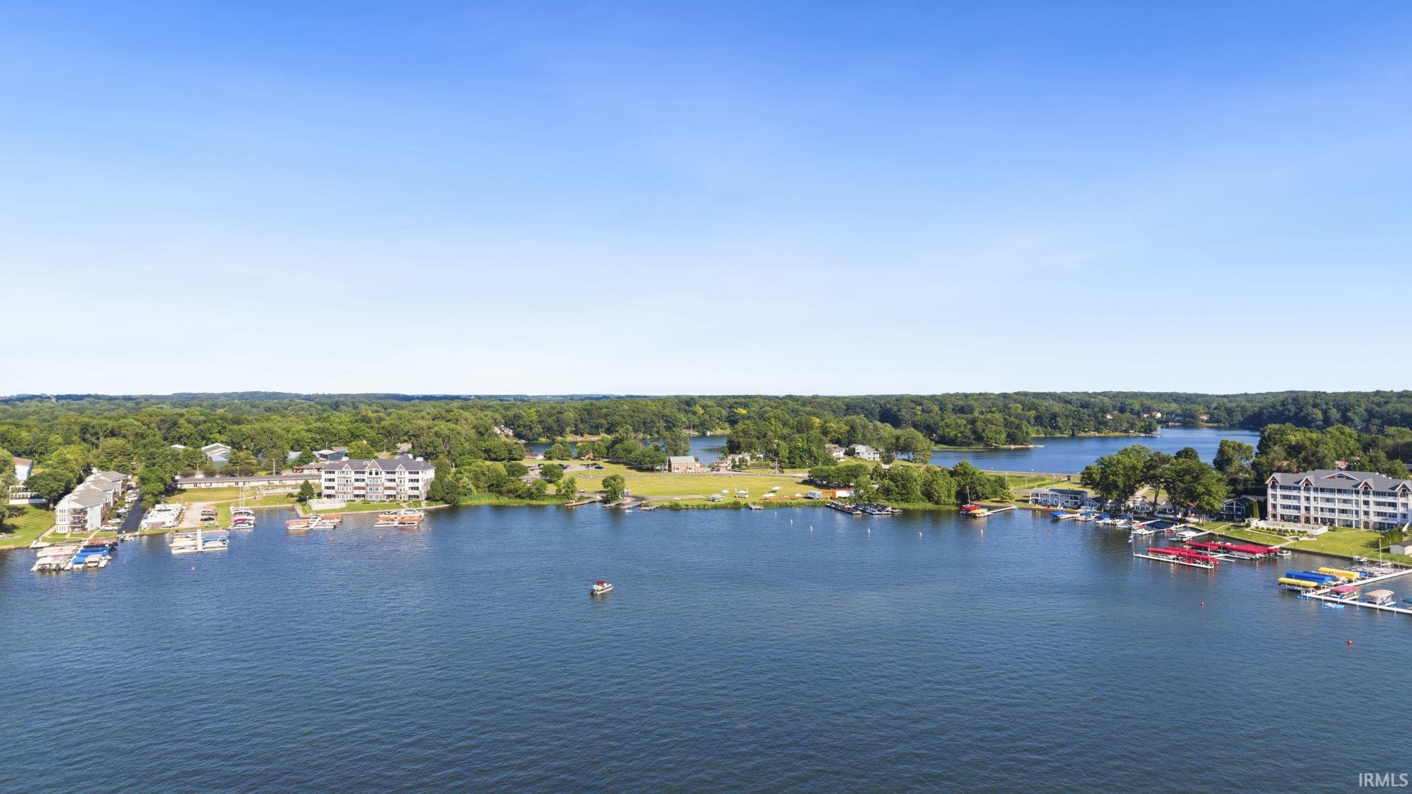 Expansive body of water surrounded by lush, mature trees