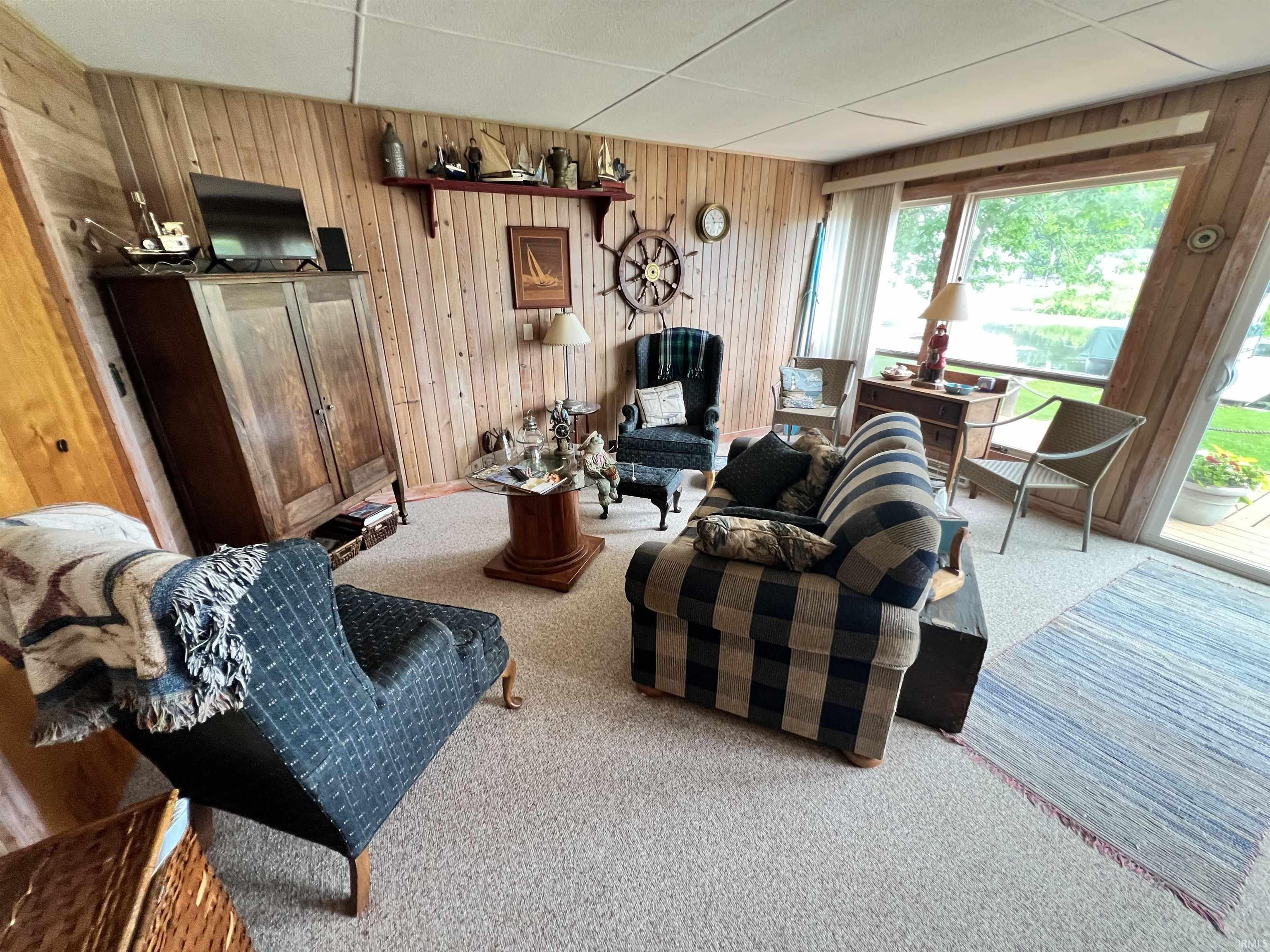 Wood-paneled interior walls with a textured ceiling