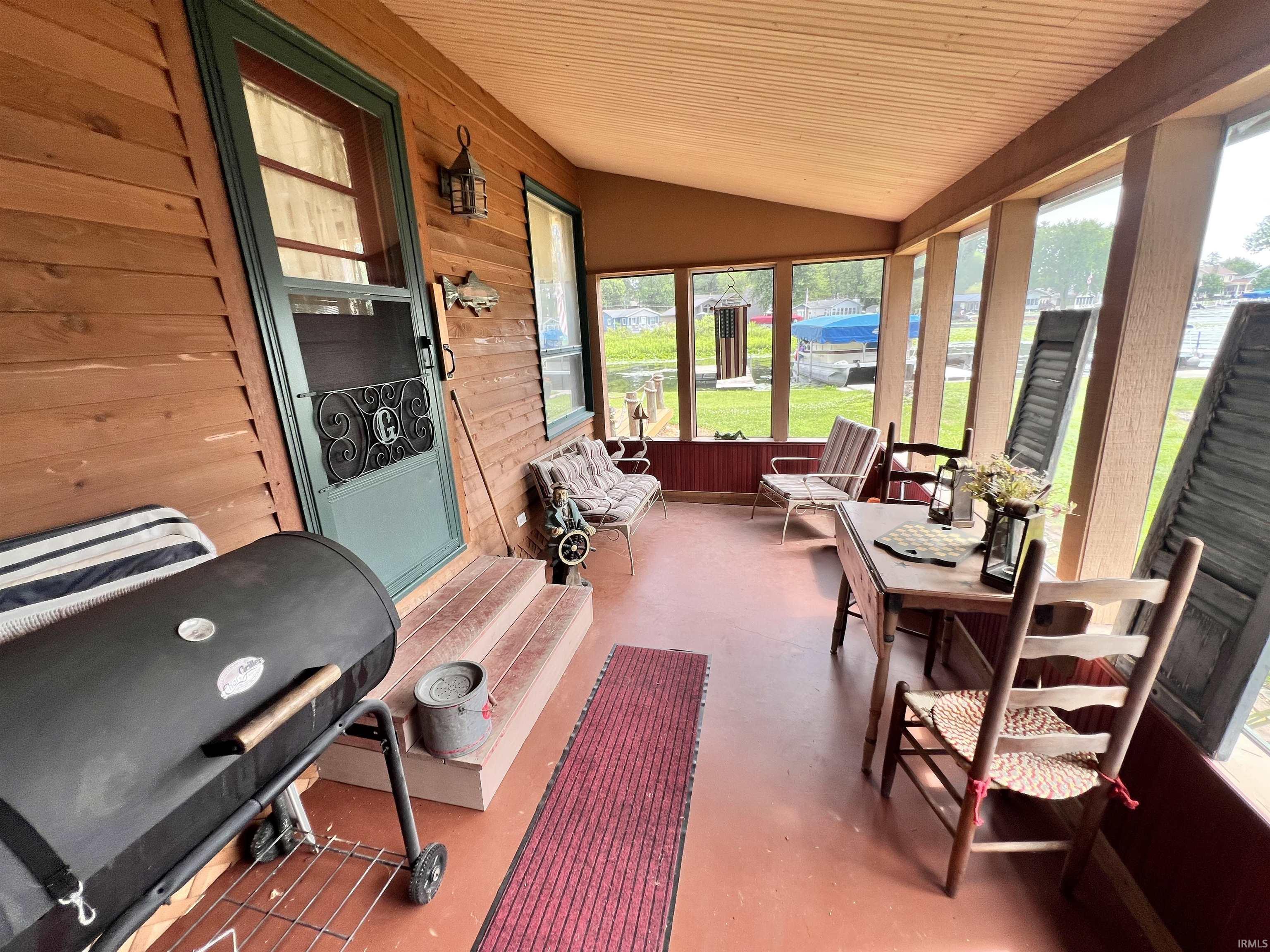 Screened porch with wood-plank siding and a wood-finish ceiling