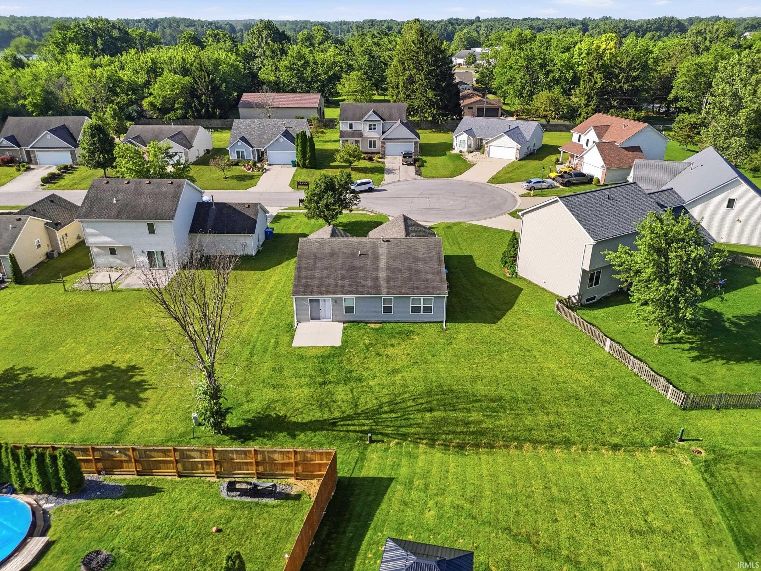 Spacious backyard with expansive green lawn and concrete patio