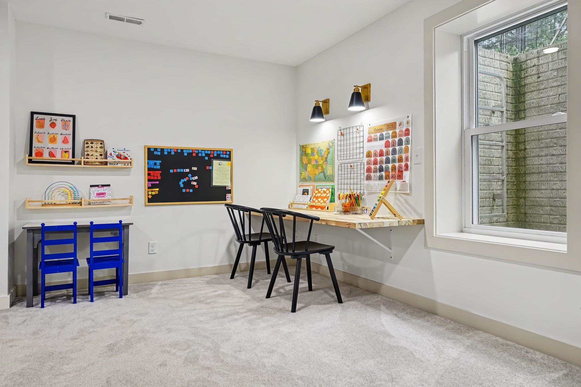 Bright room featuring light gray carpeting and white walls