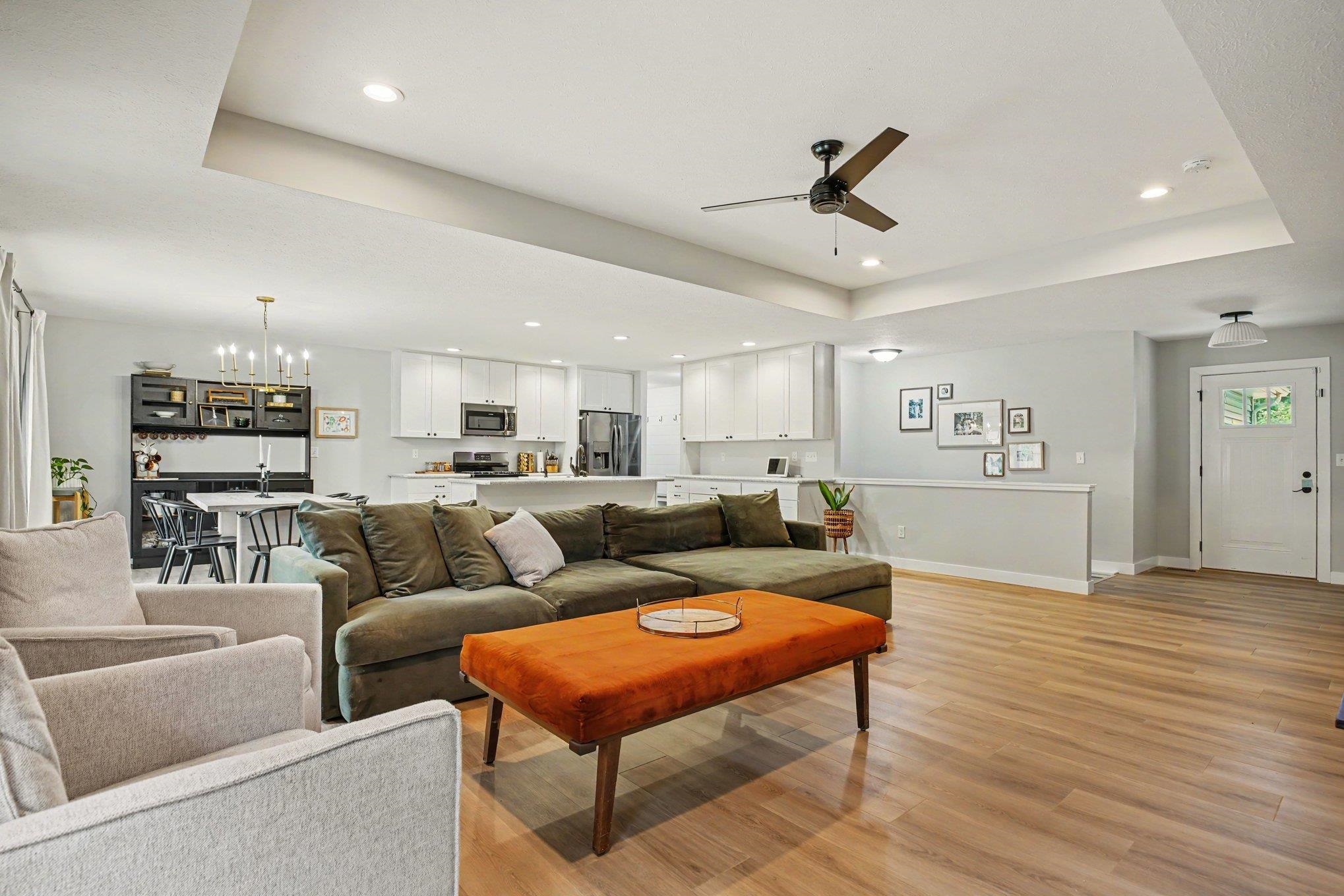 Expansive open-concept living space featuring wood-finish flooring, recessed lighting, and a ceiling fan