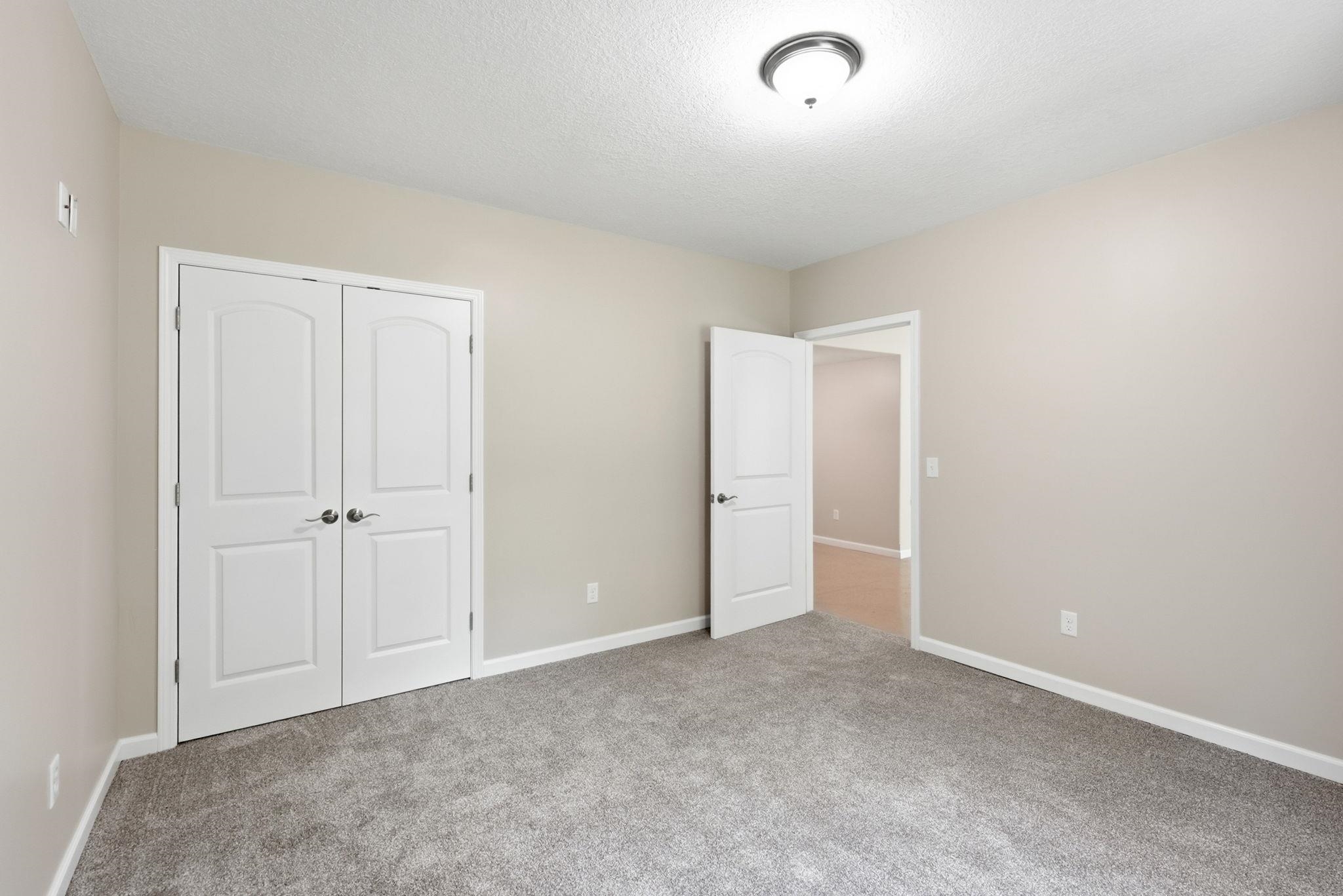 Soft gray carpeting paired with light neutral wall tones