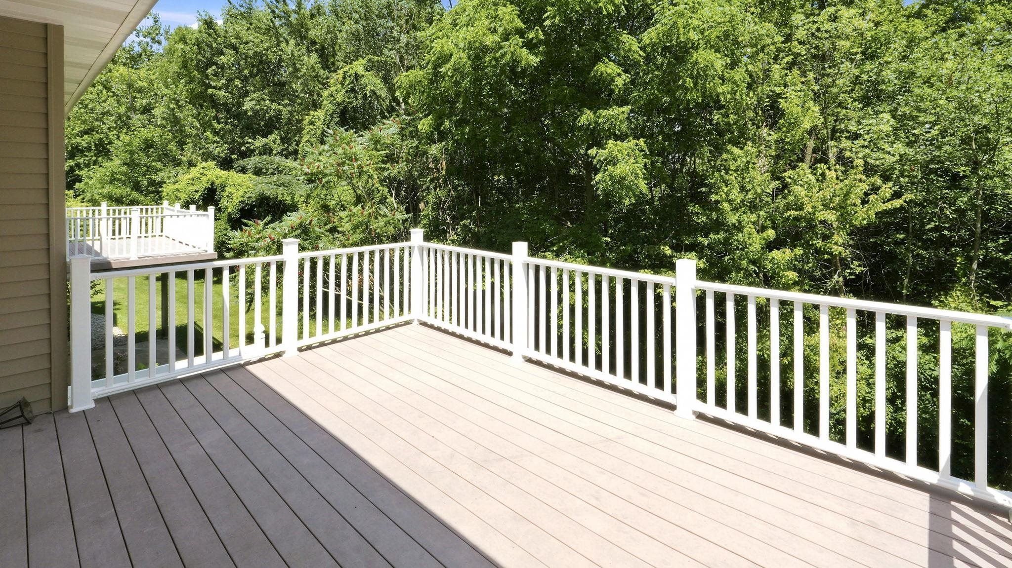 Spacious exterior deck with composite decking and white railings