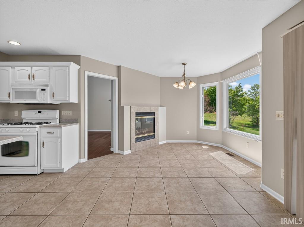 Kitchen and dining area featuring tile flooring throughout