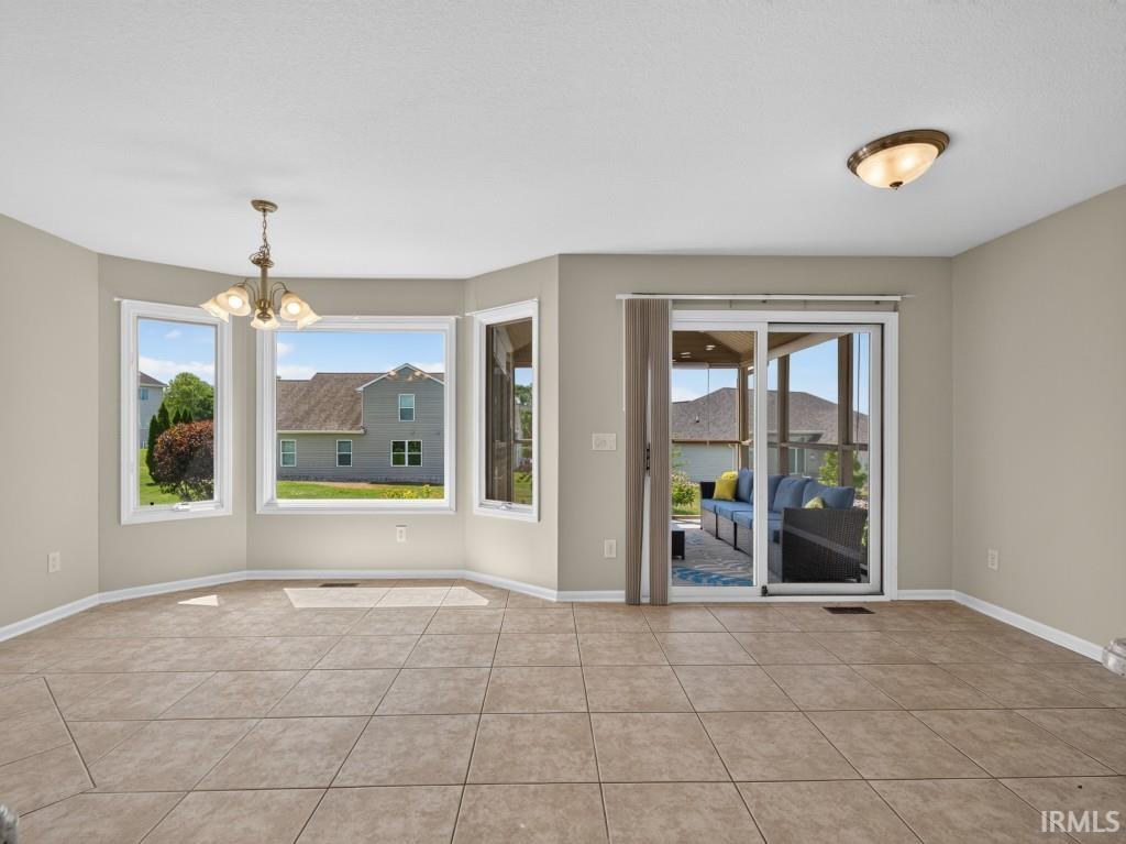 Bay window dining area with tile flooring