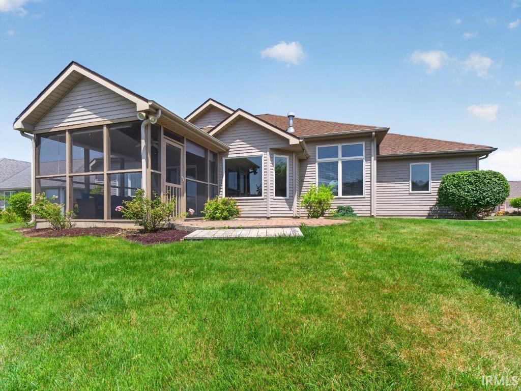 Exterior featuring a screened-in porch with a gabled roof and light-toned siding