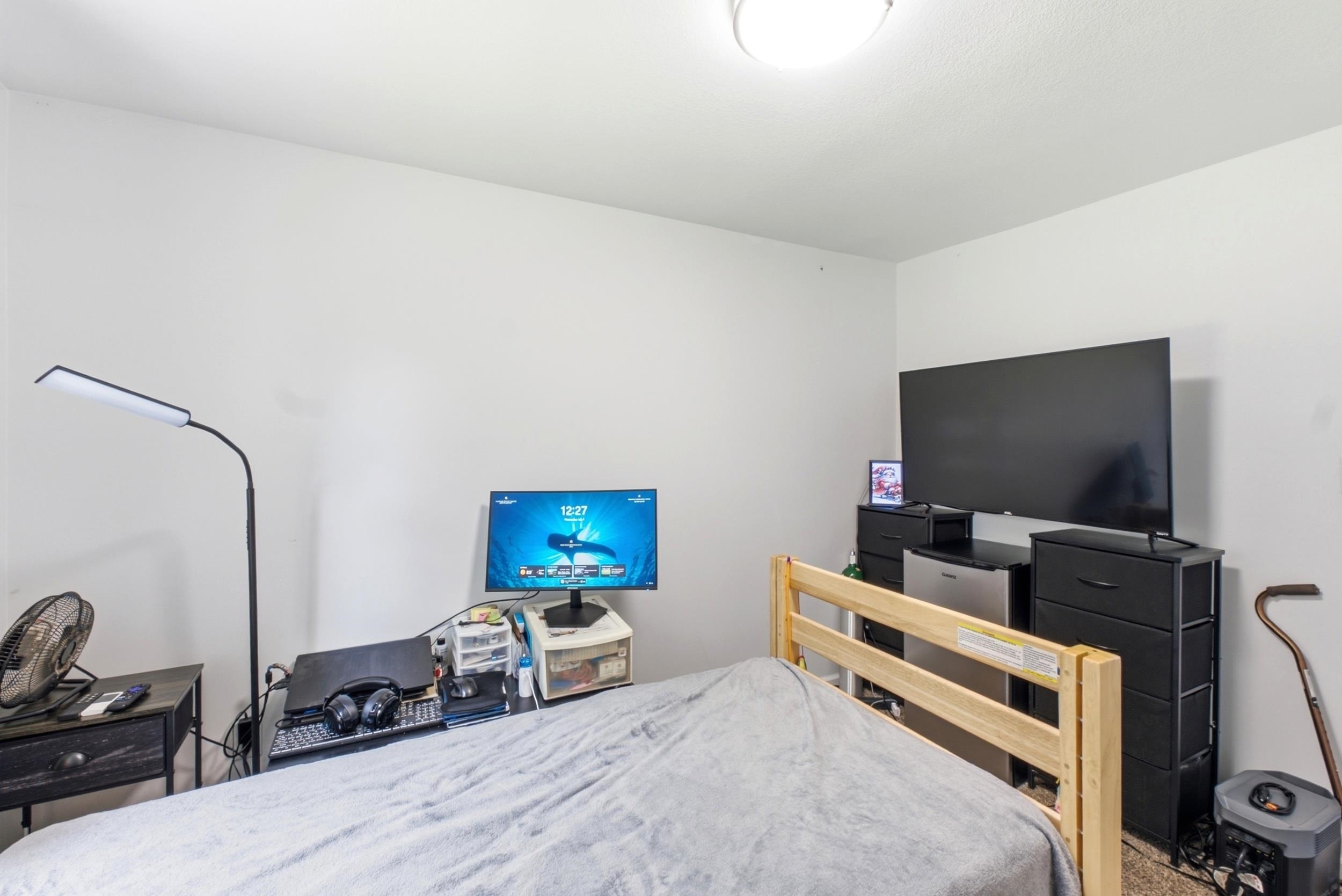 Neutral wall finishes with a ceiling-mounted light fixture