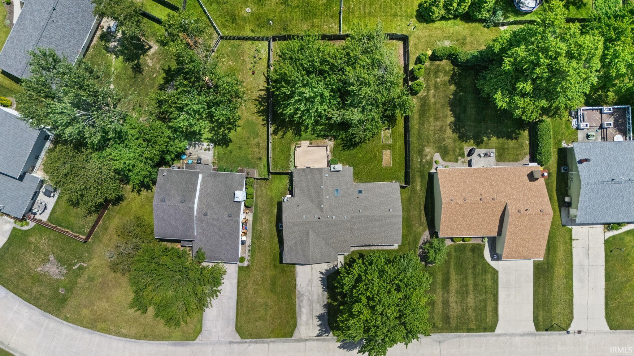 Aerial perspective showcasing three distinct residential properties