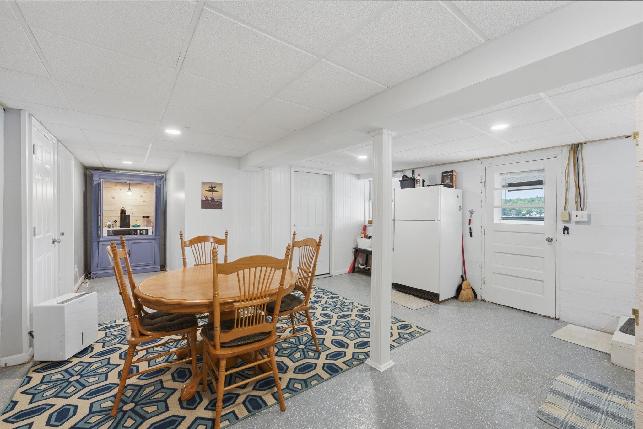 entertaining area in Lwr Lvl features walkout to Covered patio and open deck for sunning and immediate steps to expansive level lot to waterfront