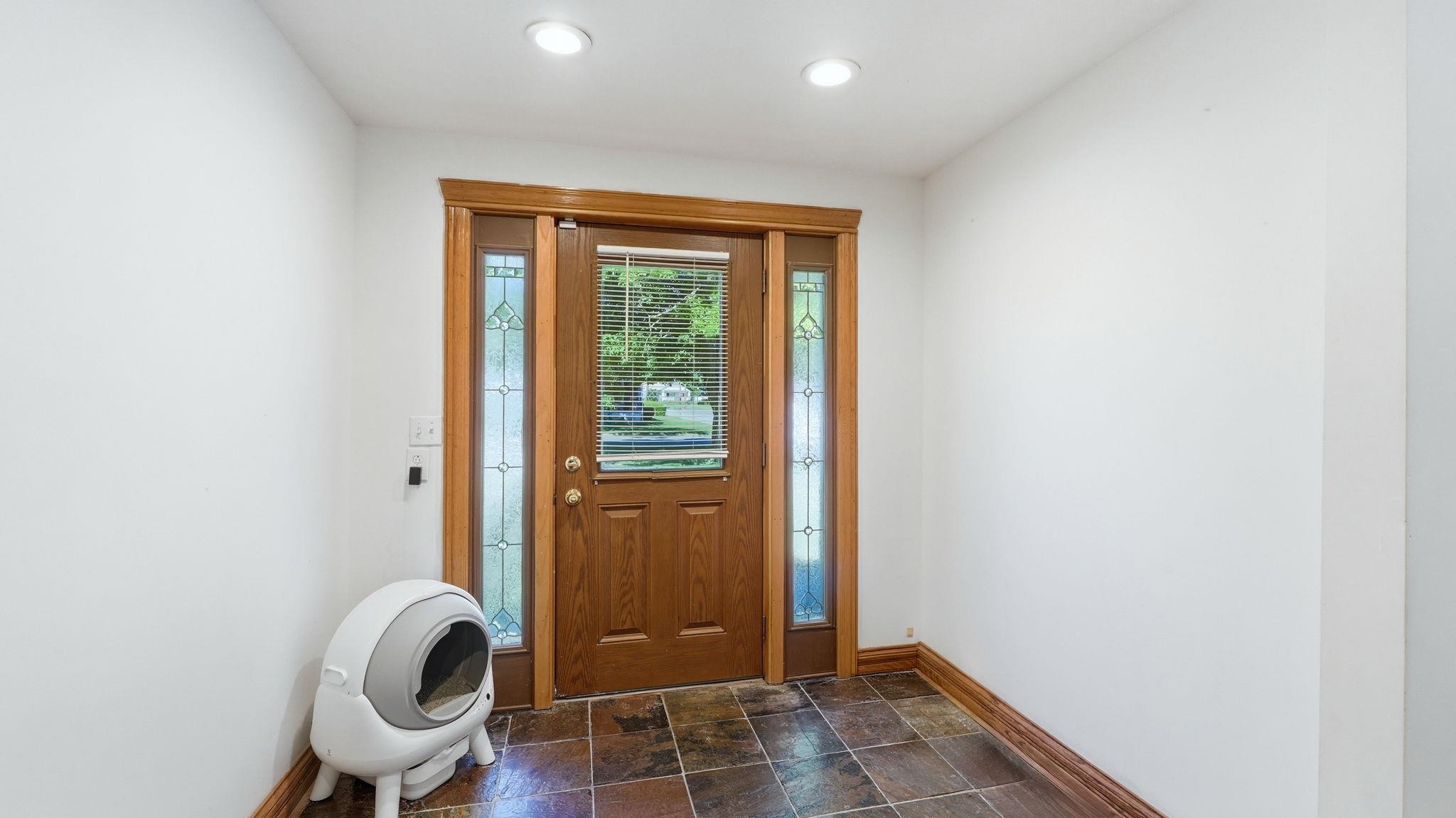 Solid wood entry door with flanking stained-glass sidelights