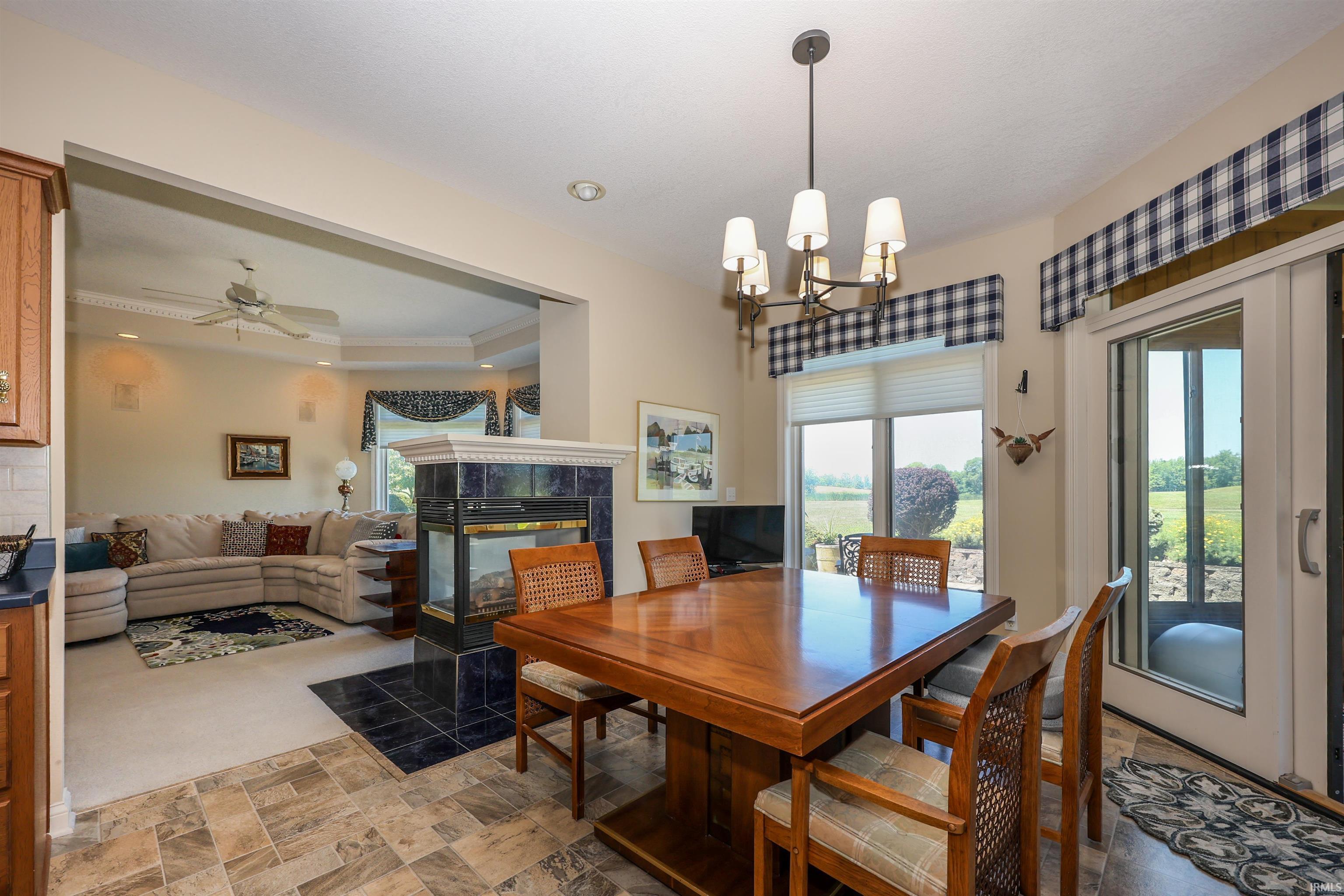Dining area with tile flooring and a multi-light chandelier
