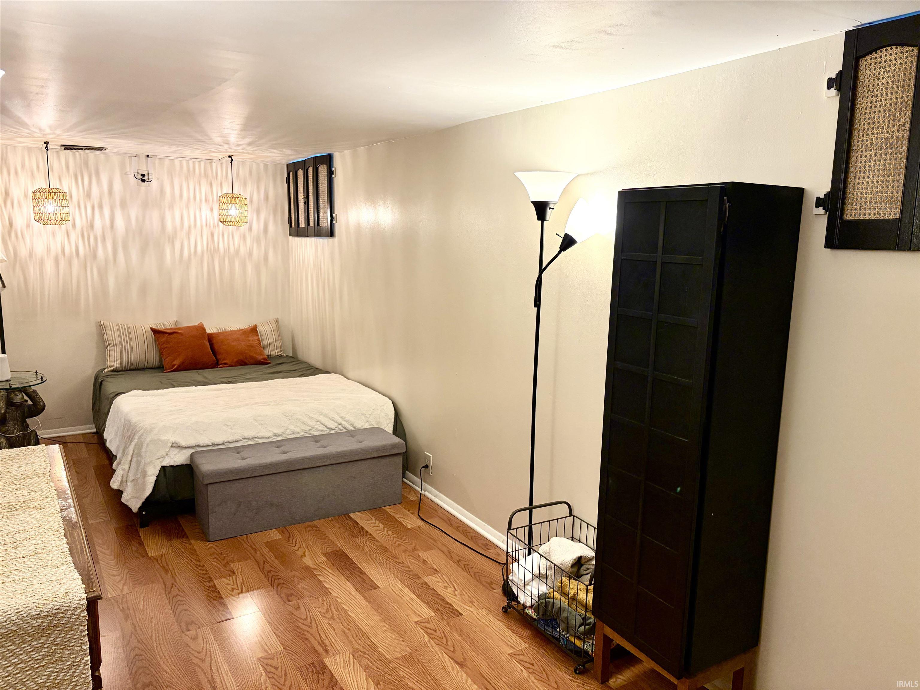 Warm wood-finish flooring complements neutral wall tones