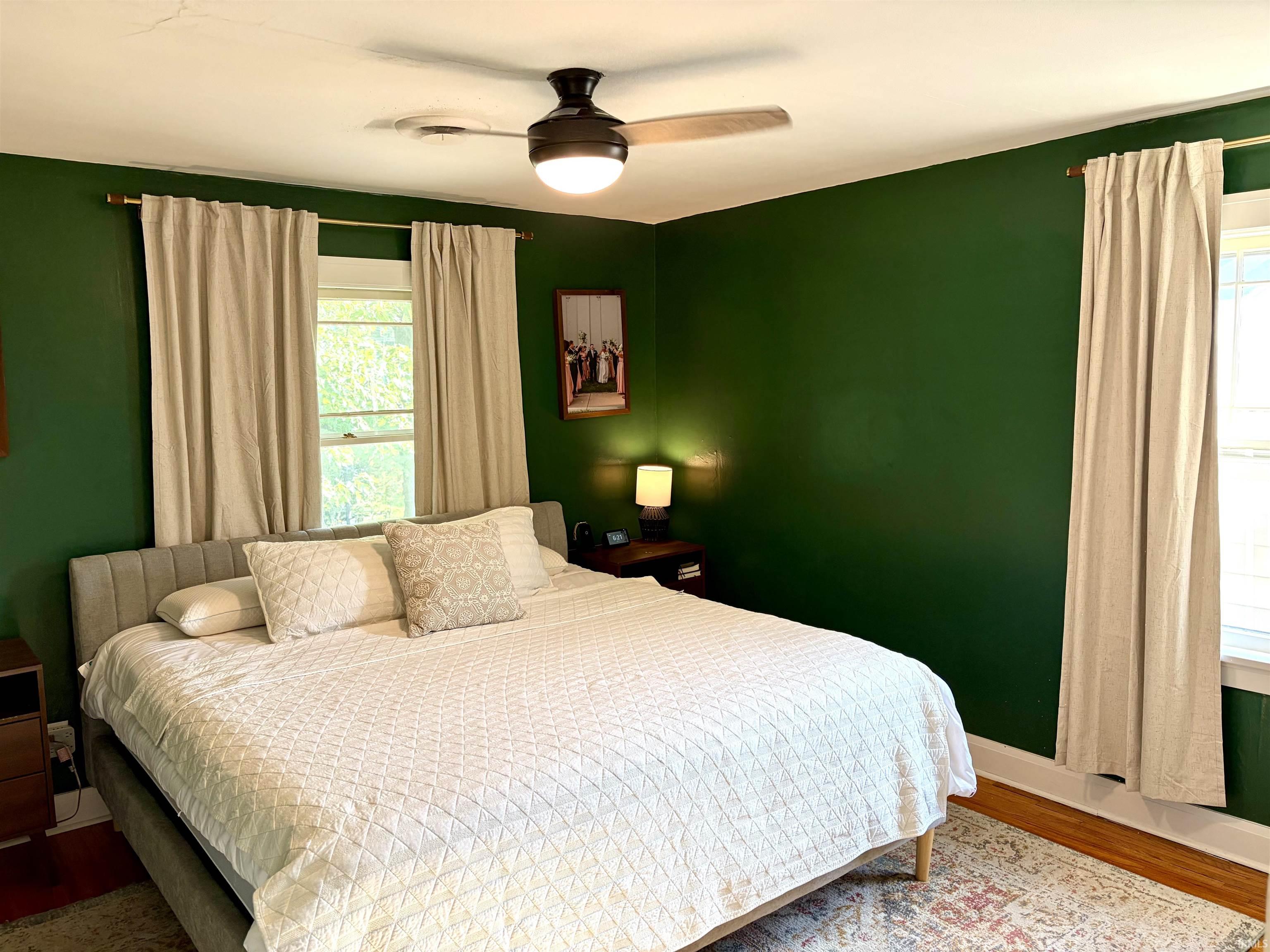 Inviting room with hardwood-finish flooring and multiple windows providing natural light
