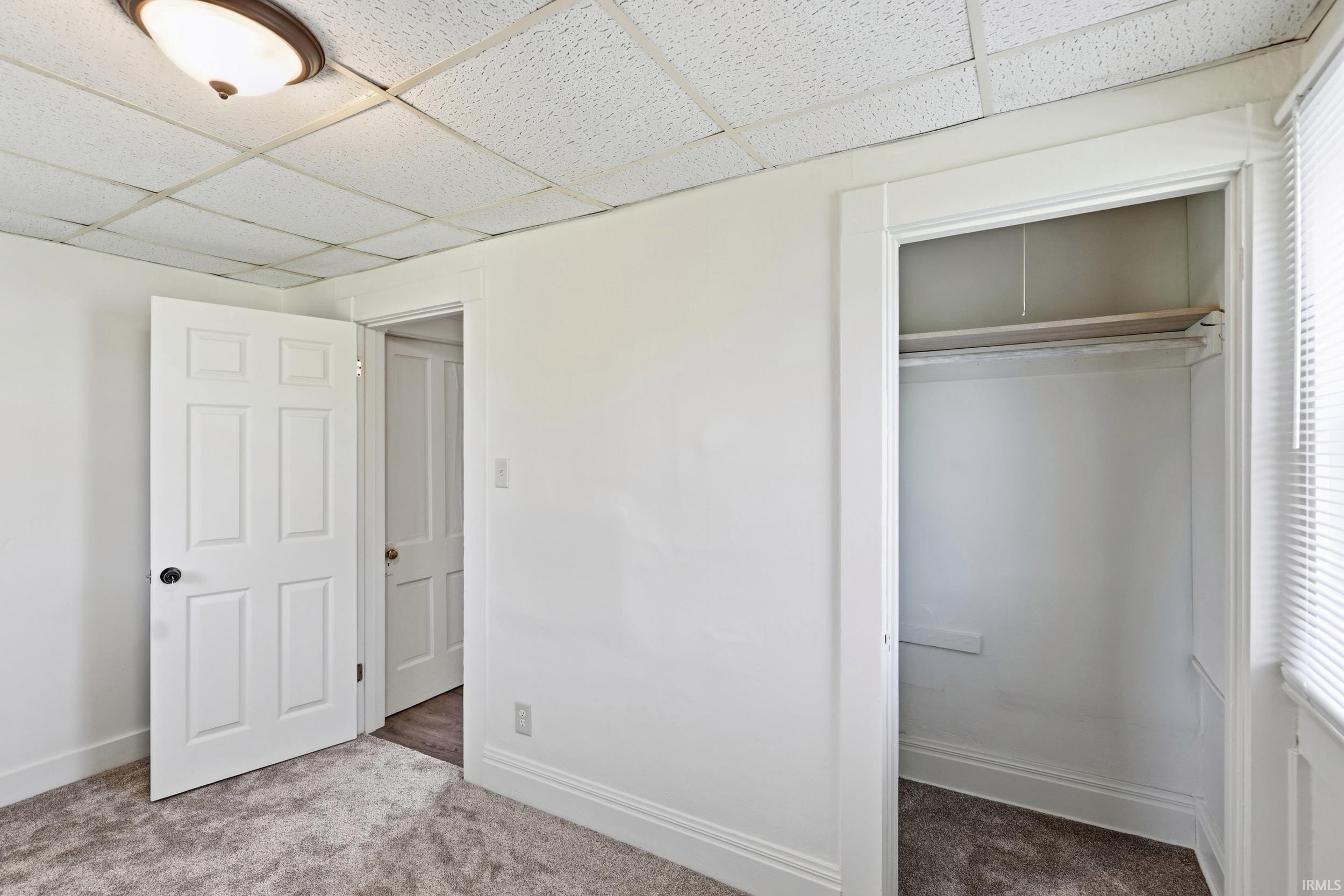 Wall-to-wall carpeting and white baseboards