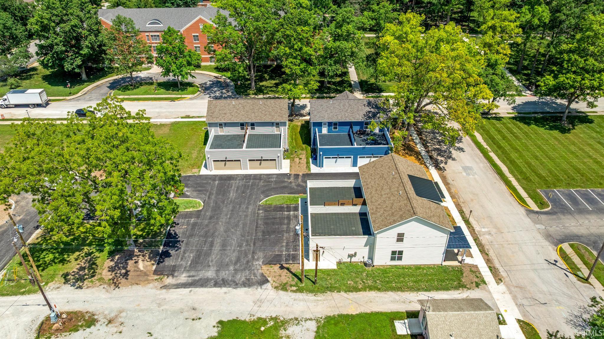 Four newly constructed properties featuring two-story designs, attached garages, and private balconies