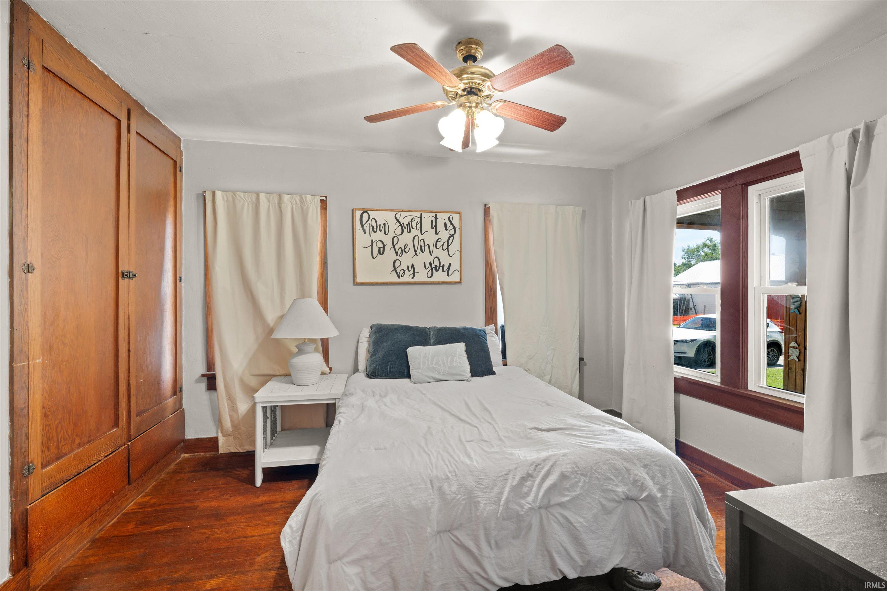 Wood-finish flooring throughout this room with built-in wooden cabinetry