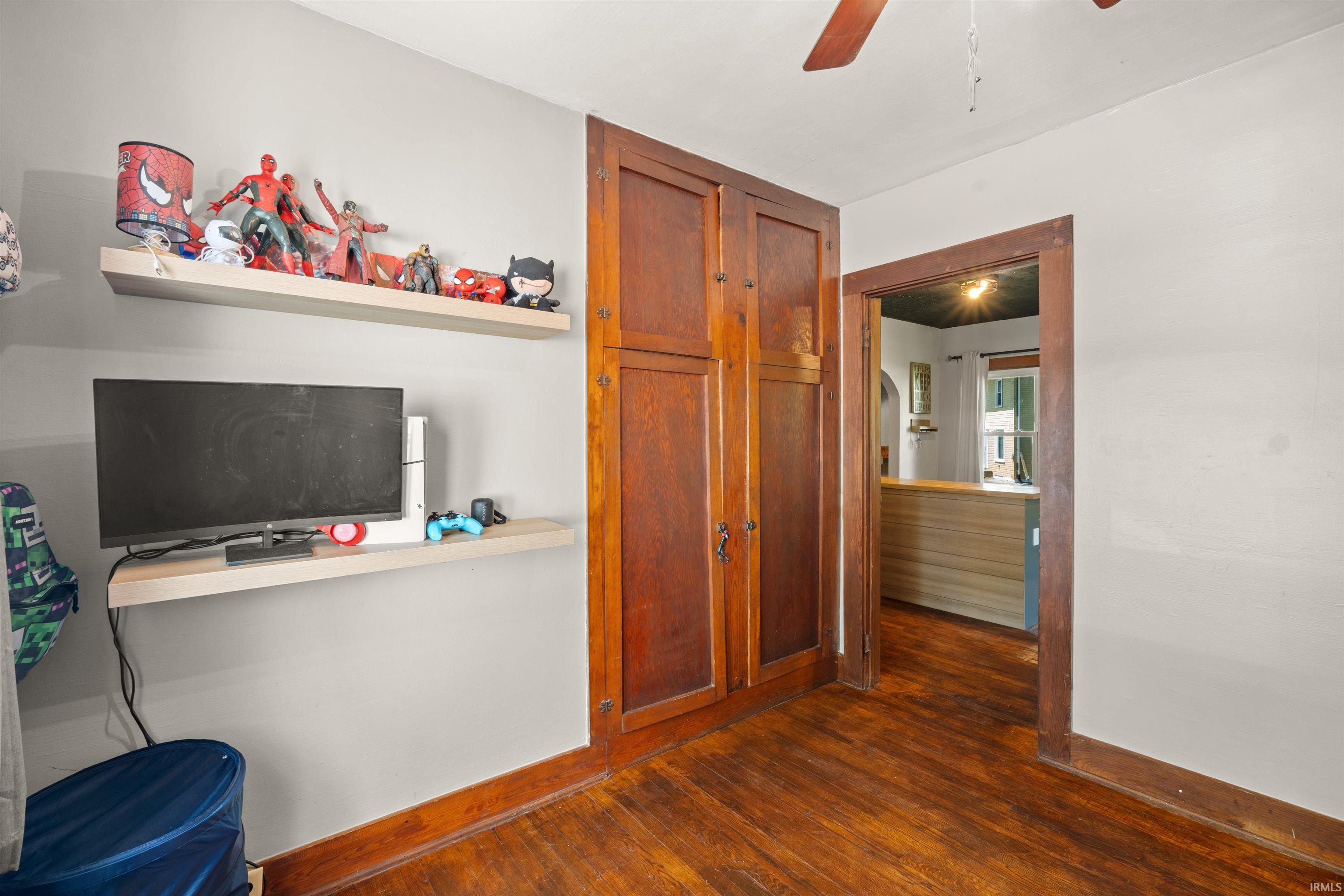 Room featuring wood-finish flooring and light-toned walls