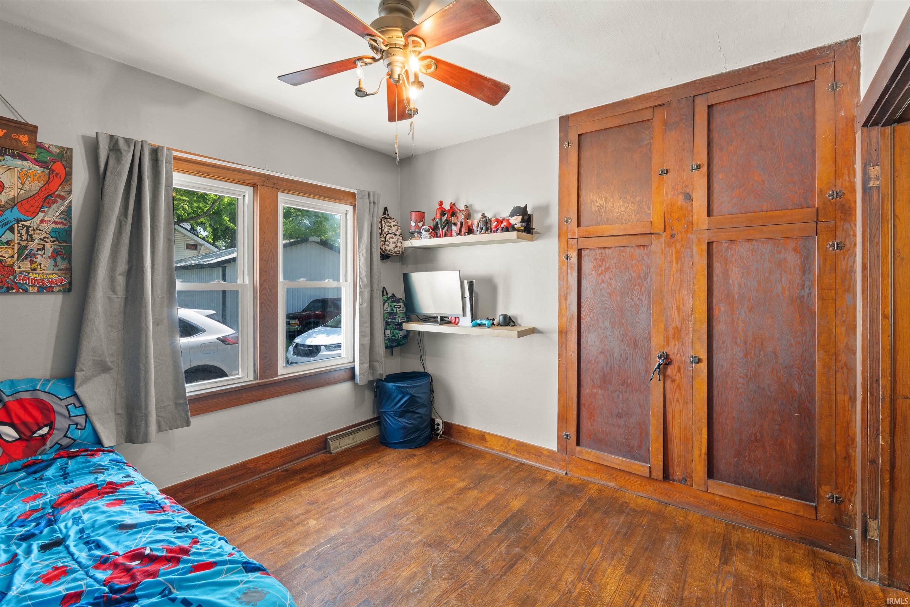 Hardwood flooring complemented by a wood-paneled built-in wardrobe
