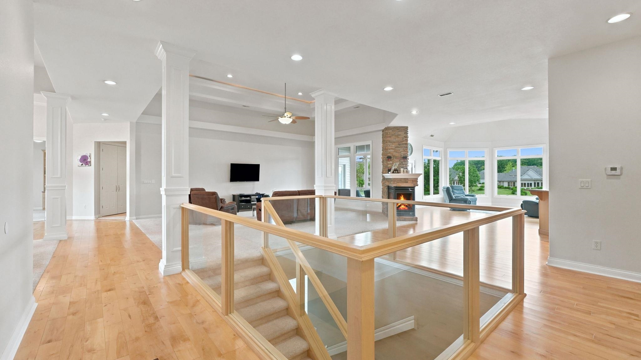 Open-concept living space featuring wood-finish flooring, recessed lighting, and white trim