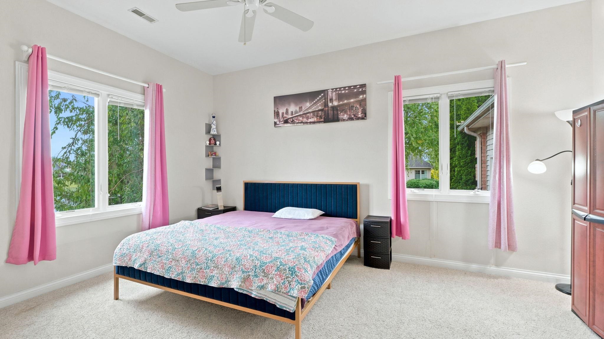 Carpeted room featuring light-colored walls and white trim