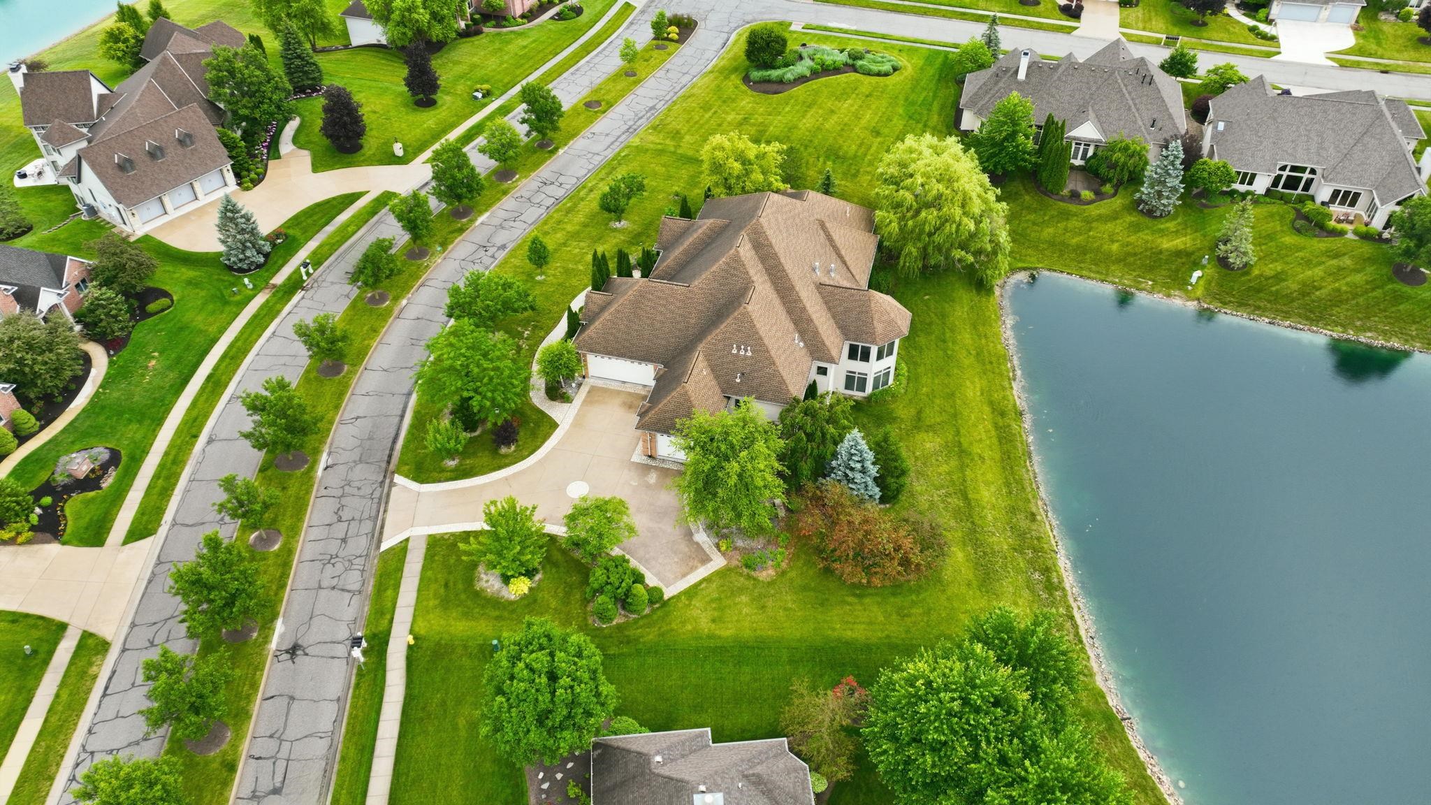 Large residential property featuring a multi-gabled roofline and a light-colored exterior