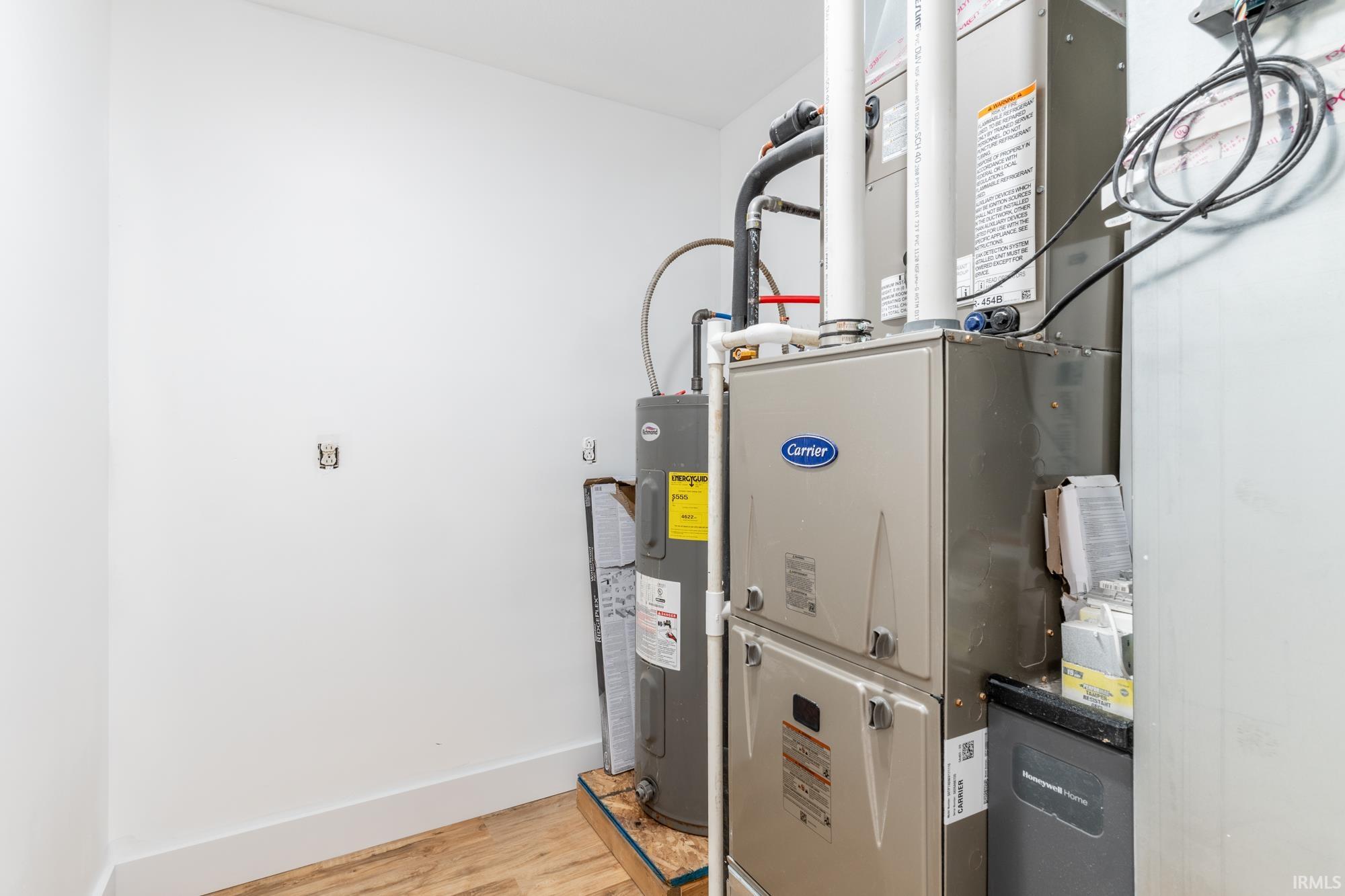 Dedicated utility space featuring a Carrier HVAC system and a water heater