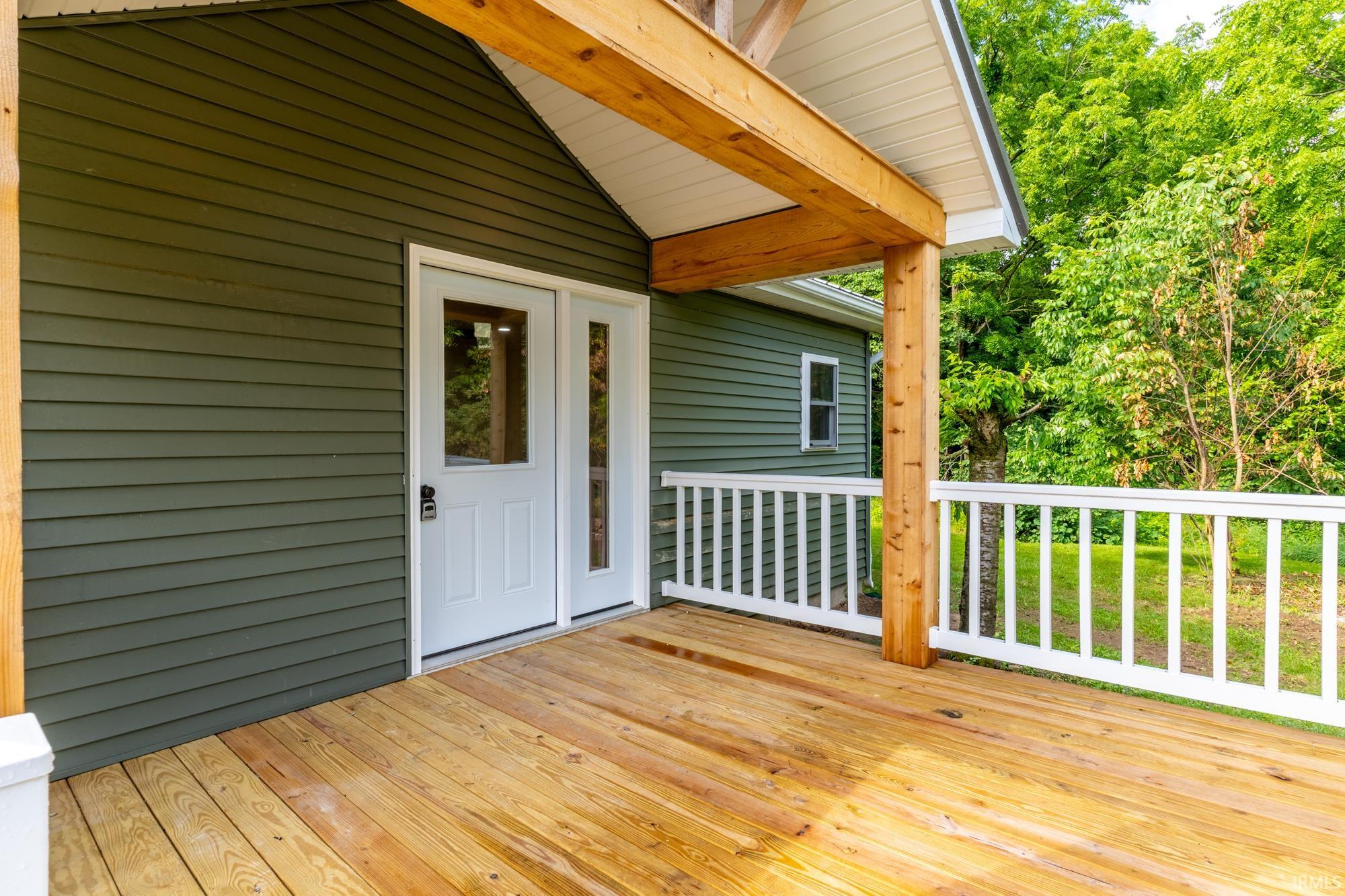 Expansive wood-finish deck with white railings