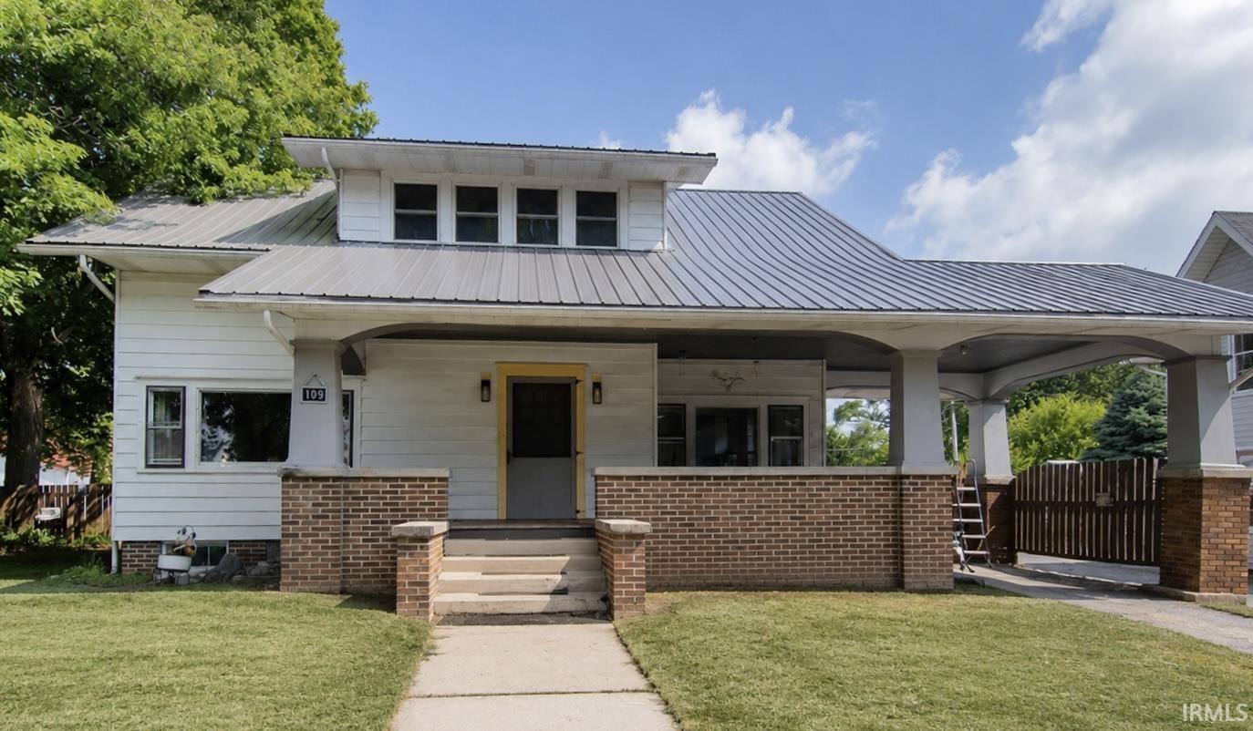 White siding exterior with a standing seam metal roof
