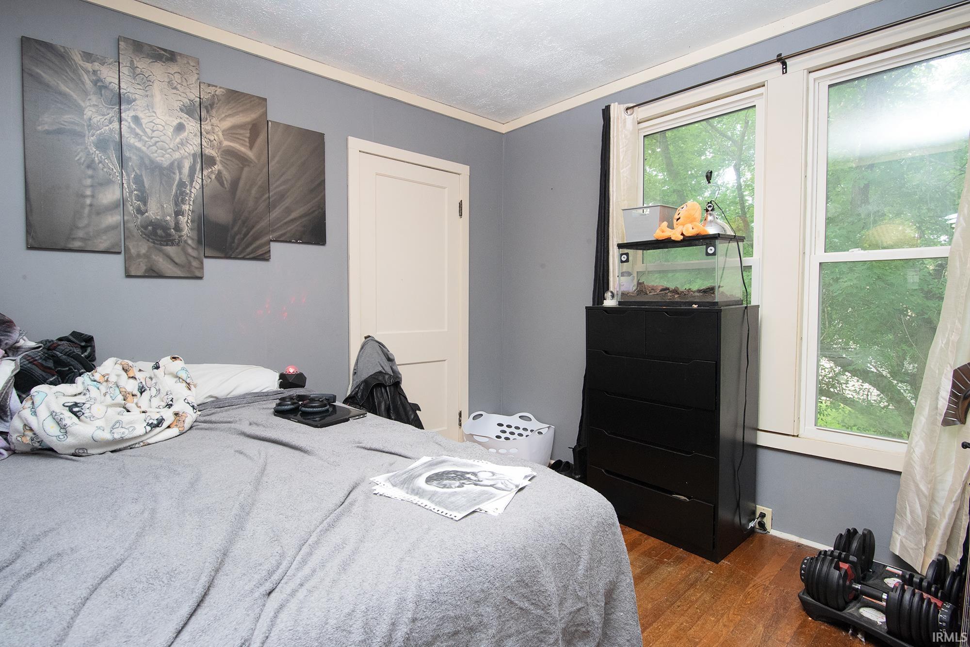 Hardwood flooring and dual windows with natural light