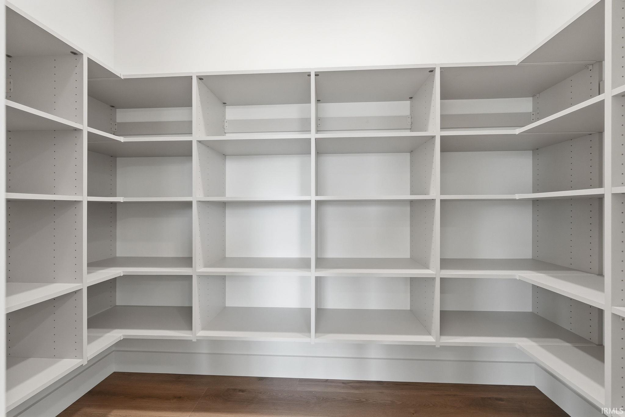 Custom built-in shelving system with white finishes, offering extensive storage