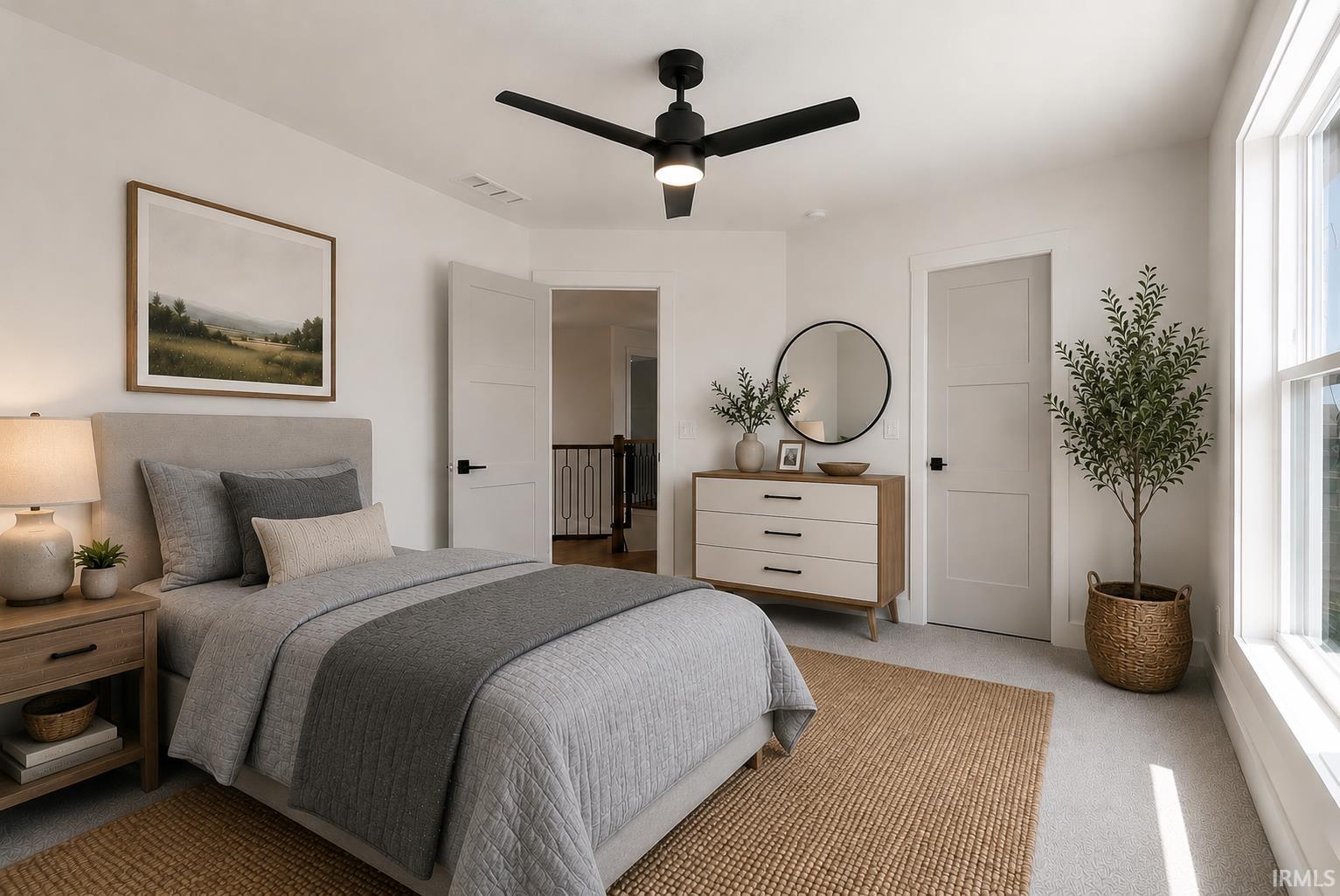 Carpeted room featuring a ceiling fan with integrated lighting, a large window, a solid panel interior door, and a wood-finish nightstand