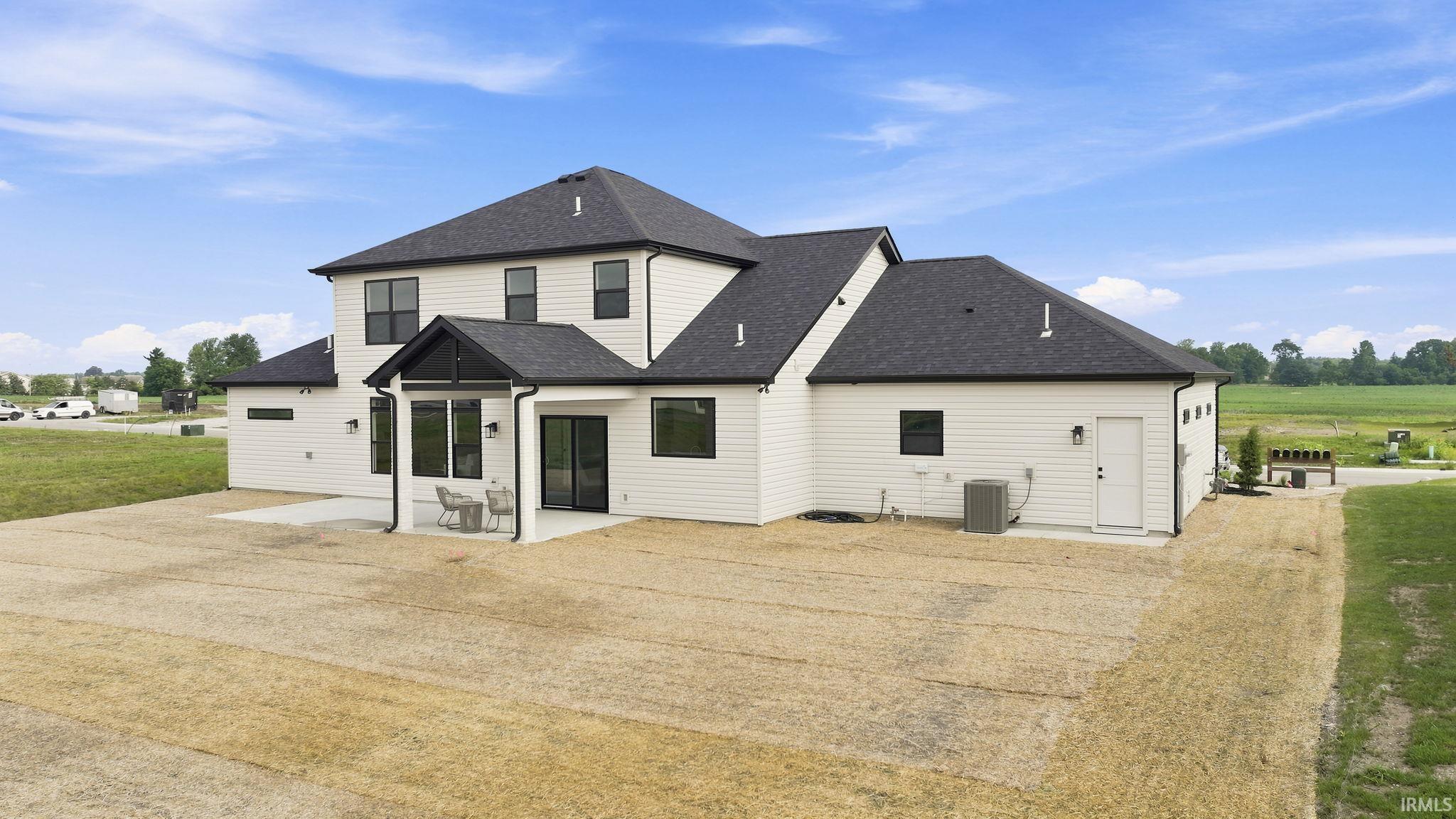 Contemporary two-story residence featuring white siding and a dark shingle roof