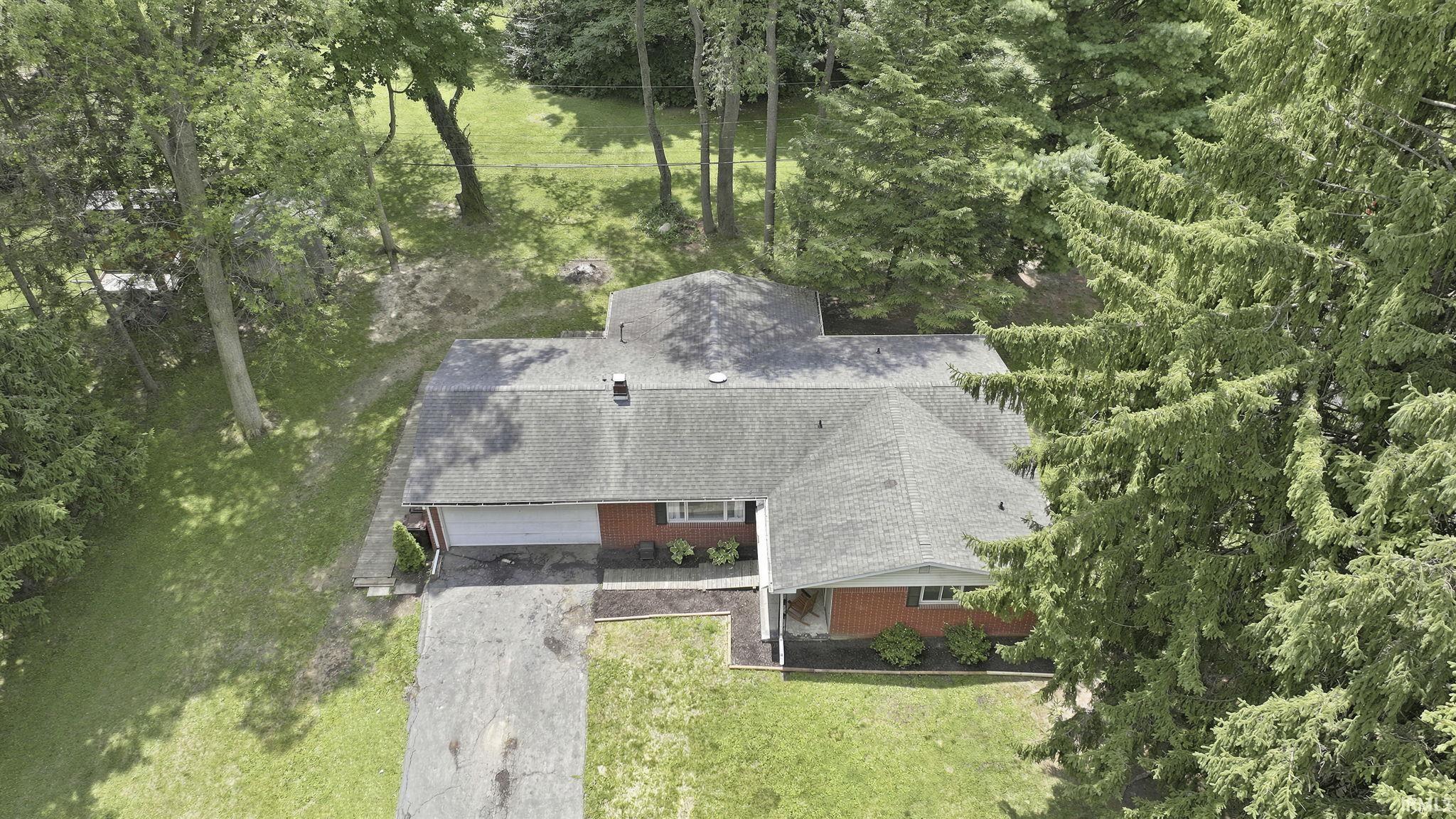 Ranch-style residence featuring a prominent gabled roof and attached garage