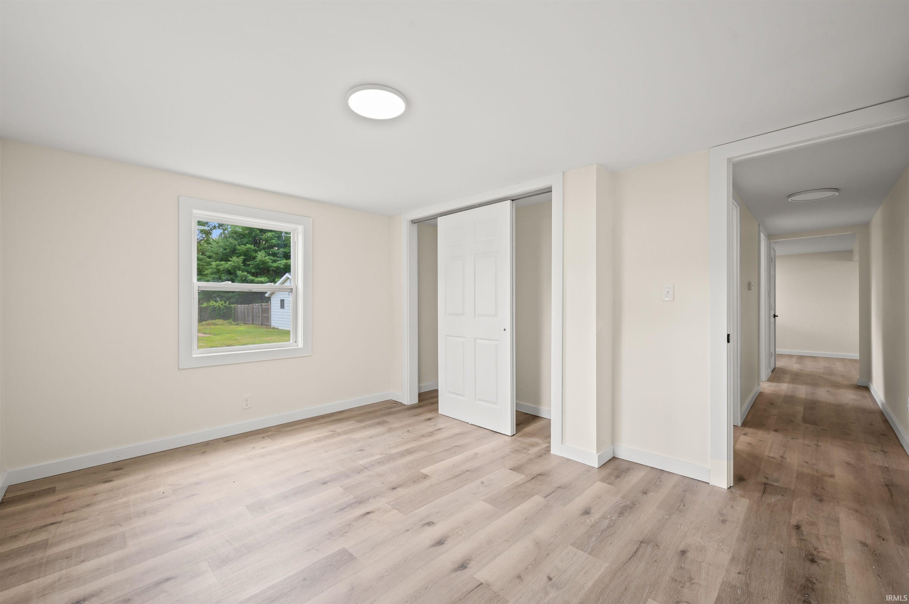 Neutral wall tones complemented by wood-finish flooring