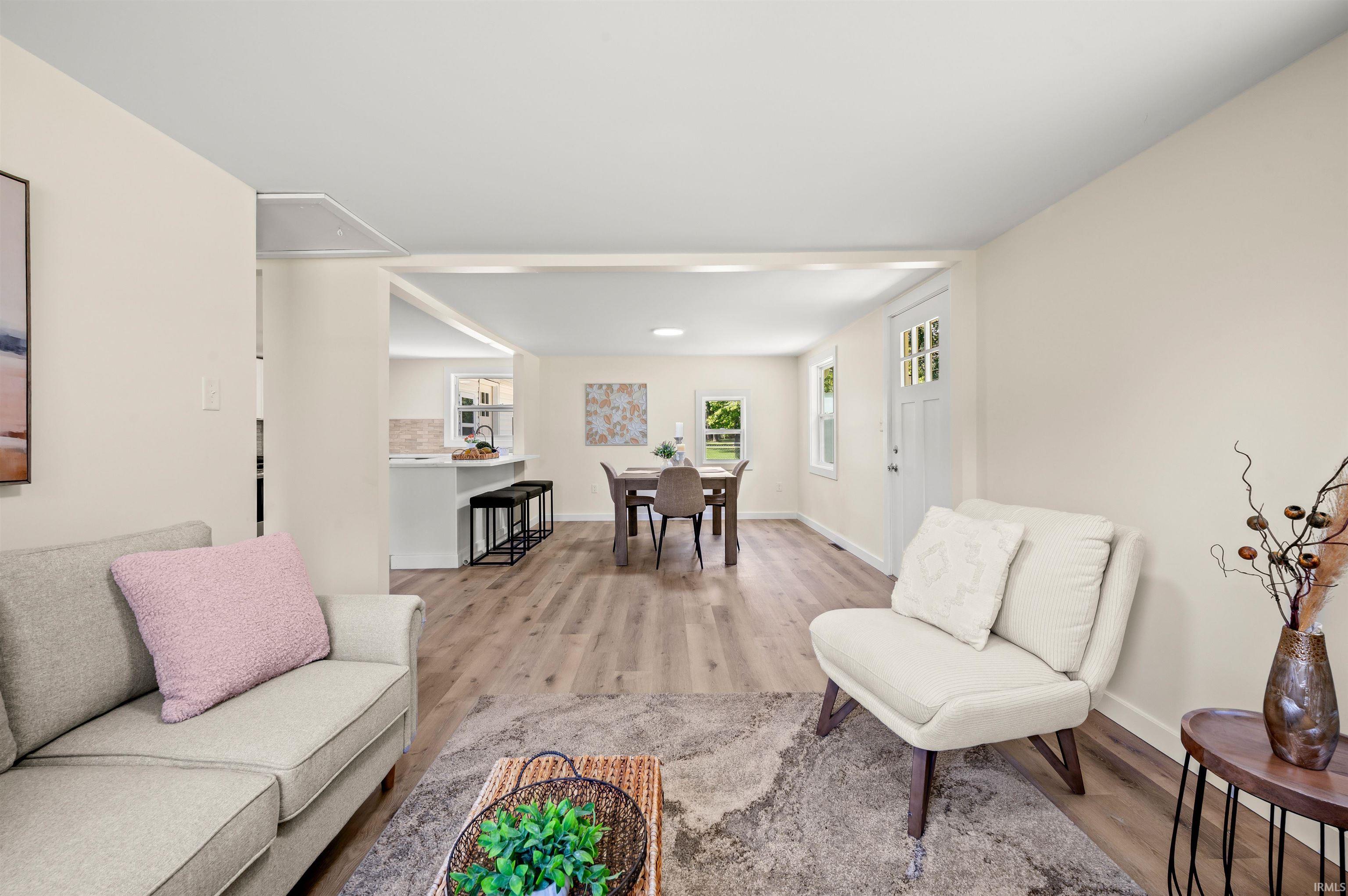 Open concept living area featuring wood-finish flooring