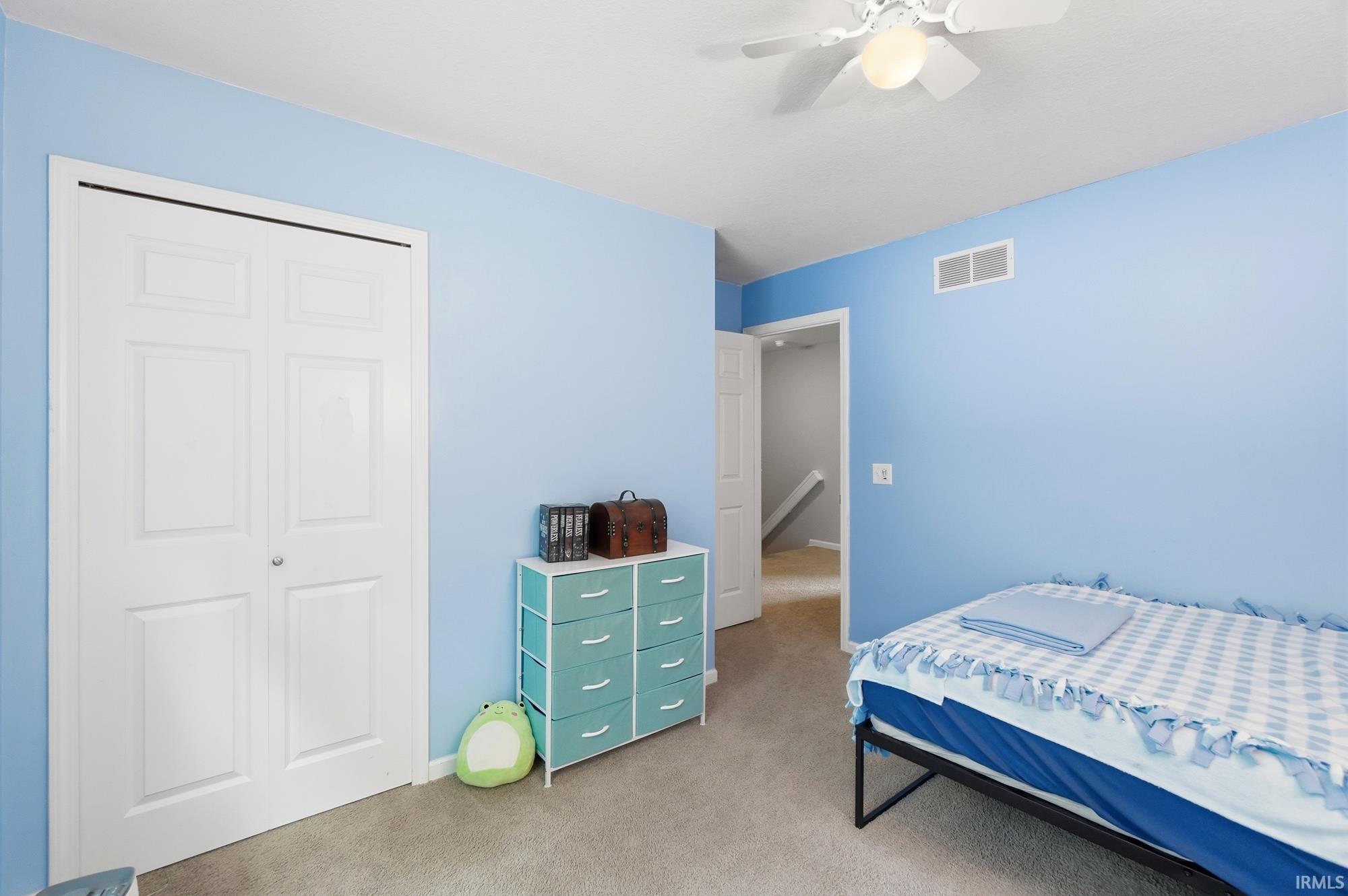 Carpeted room featuring light blue walls