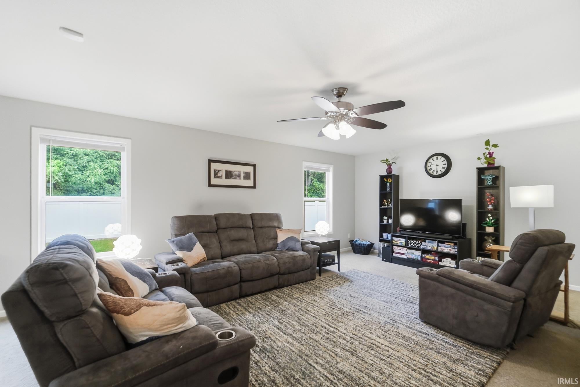 Recessed lighting, ceiling fan with integrated light fixture, multiple windows, and light gray wall paint