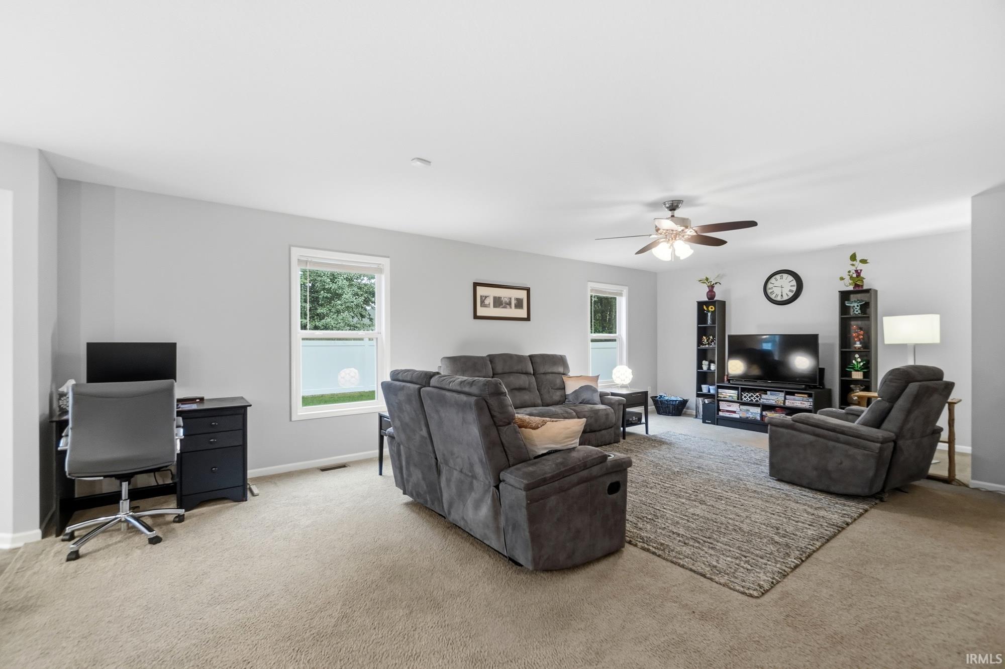 Recessed lighting, ceiling fan, and multiple windows offer ample illumination