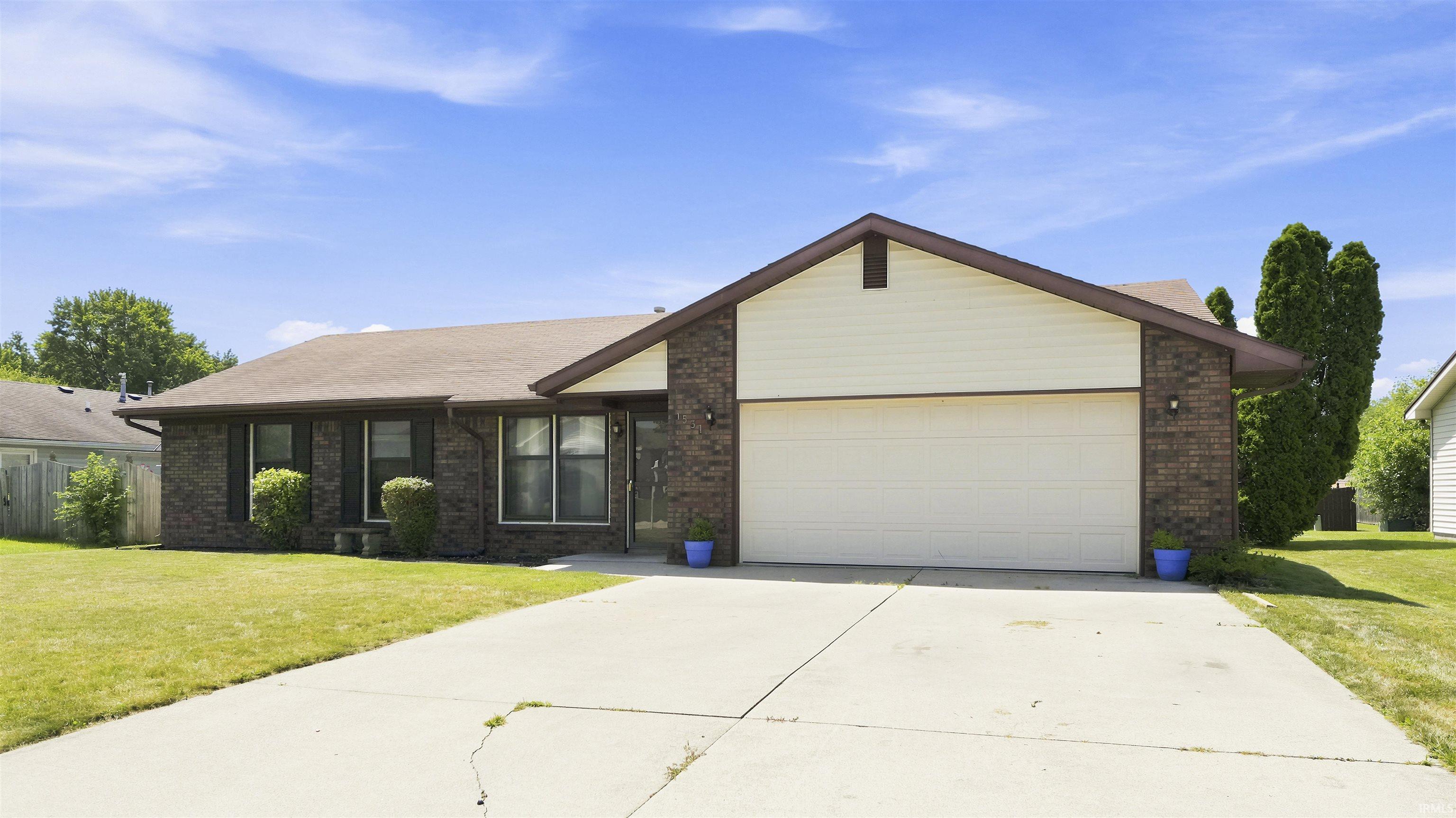 Brick veneer exterior with siding accents and a pitched roofline