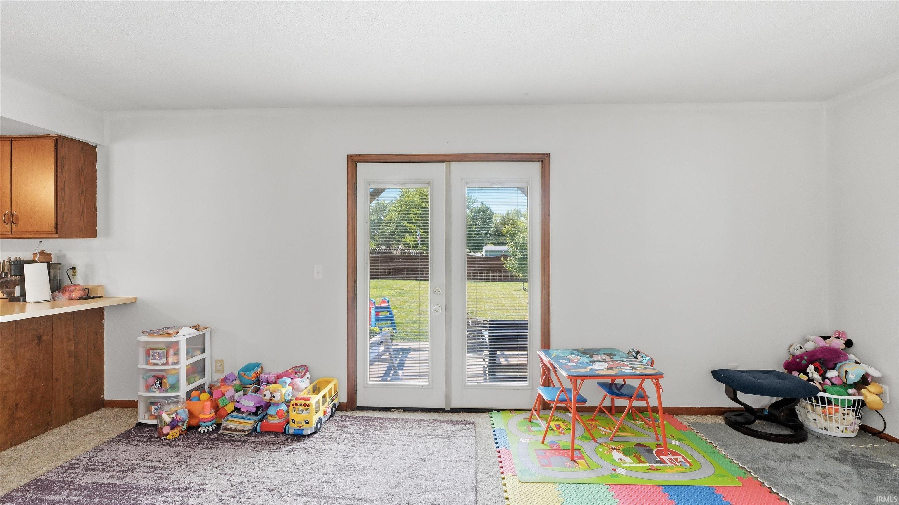 White French doors opening to an exterior patio and green lawn