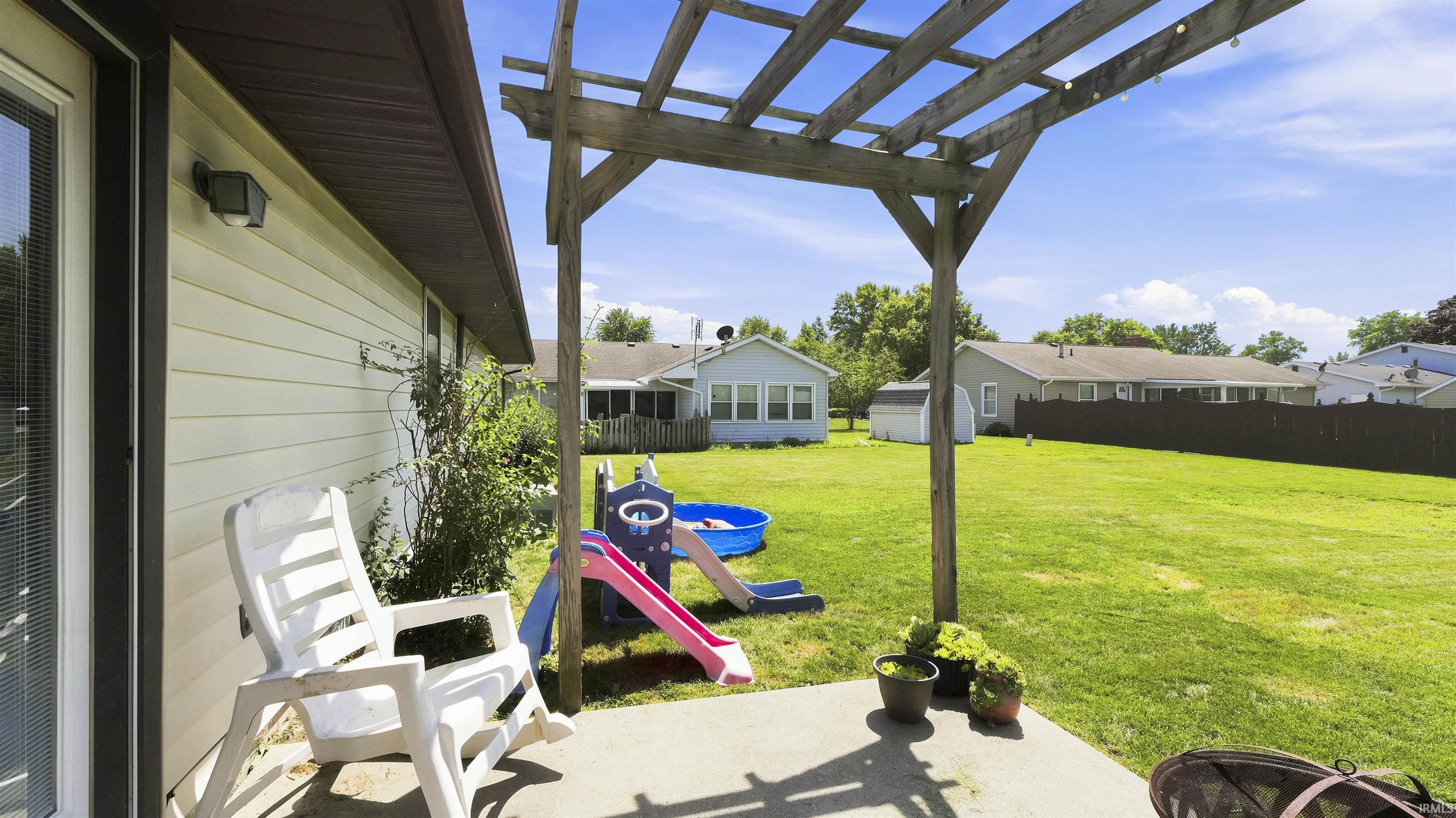 Concrete patio featuring a wooden pergola