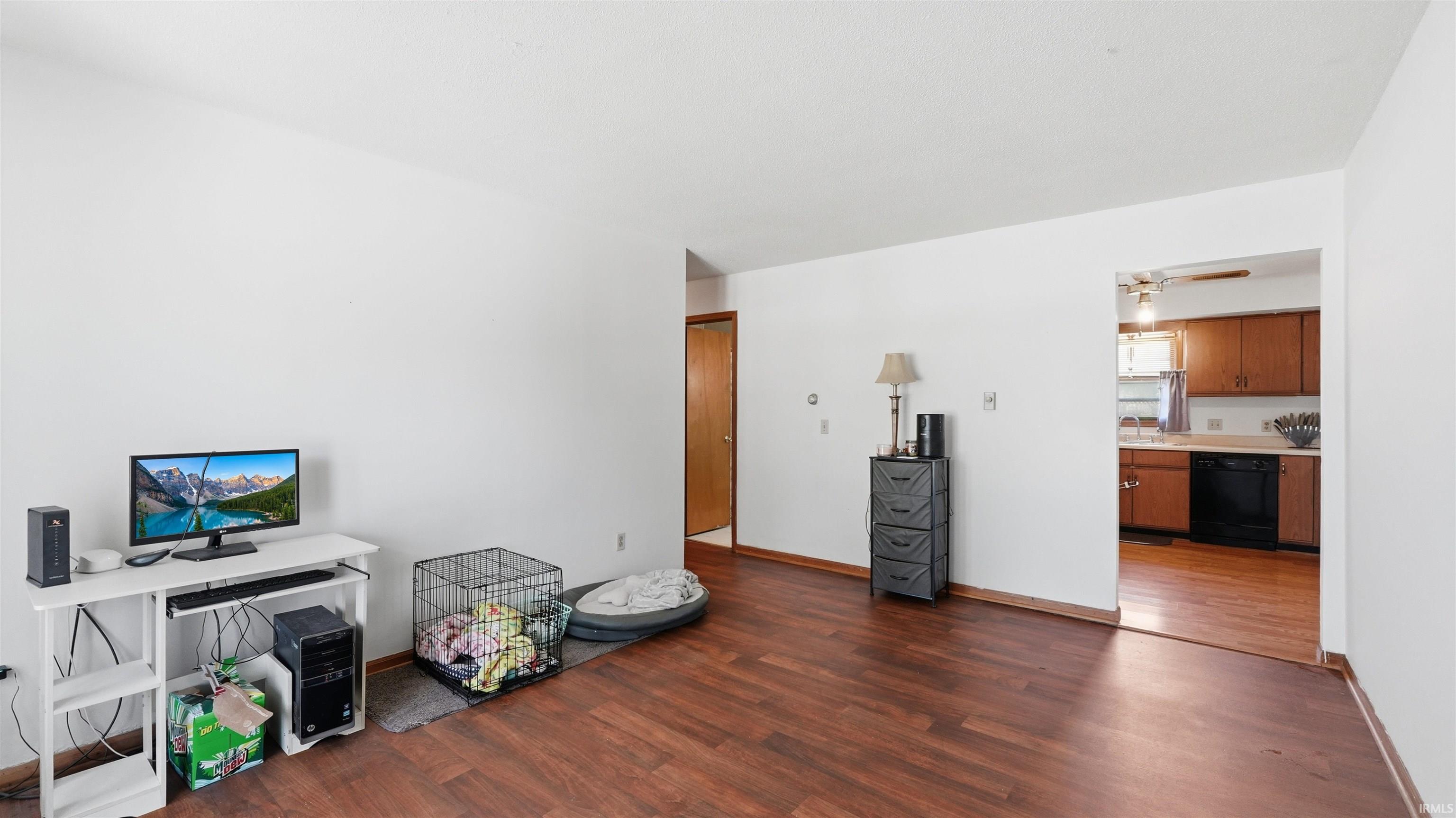 Living area featuring wood-finish flooring and white wall finishes