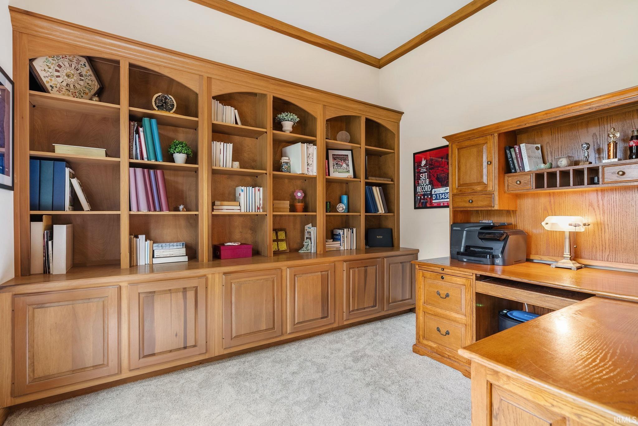 Built-in wood cabinetry with arched open shelving and lower storage